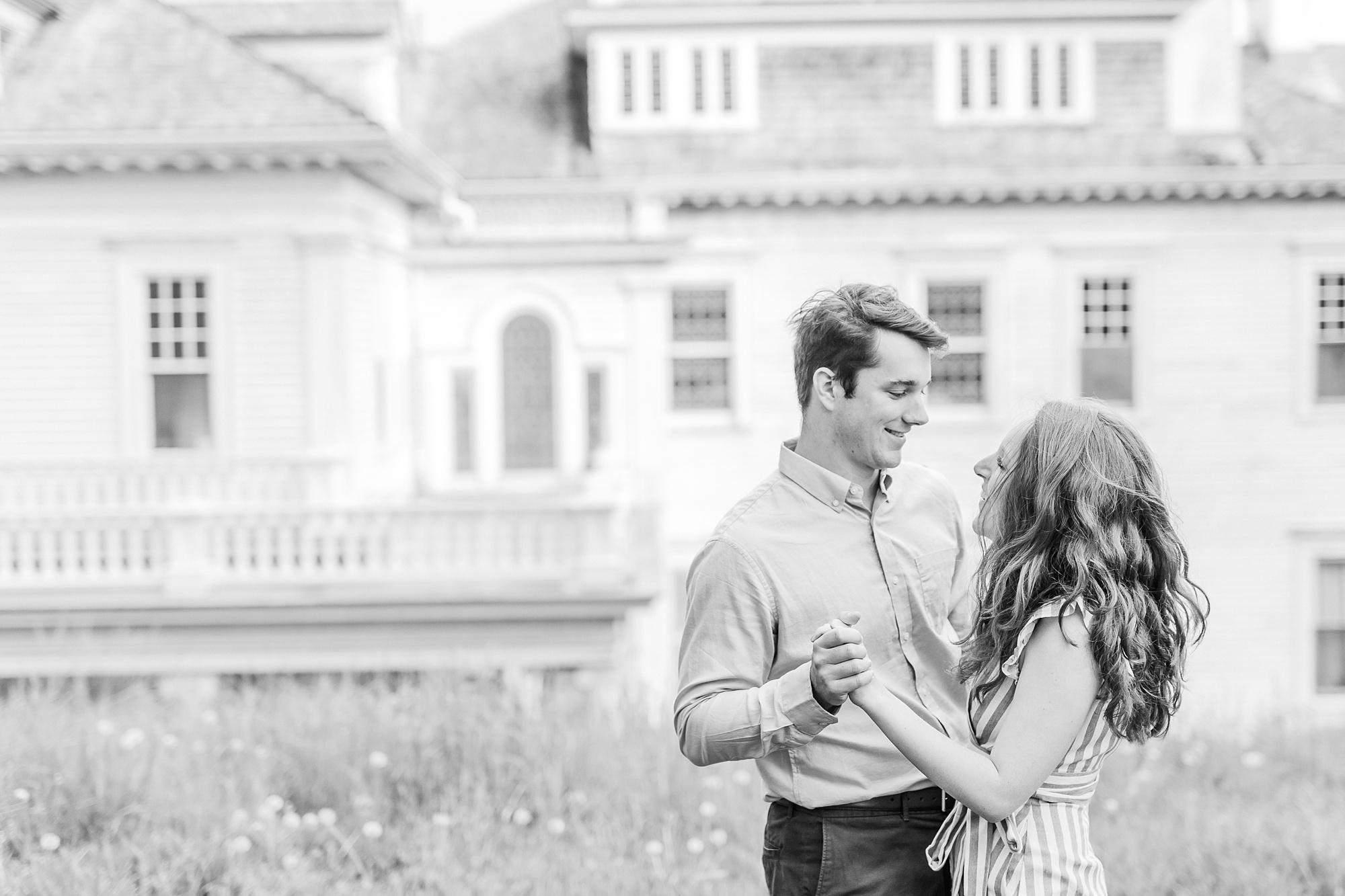 engaged couple dances in front of Moses Cone Manor