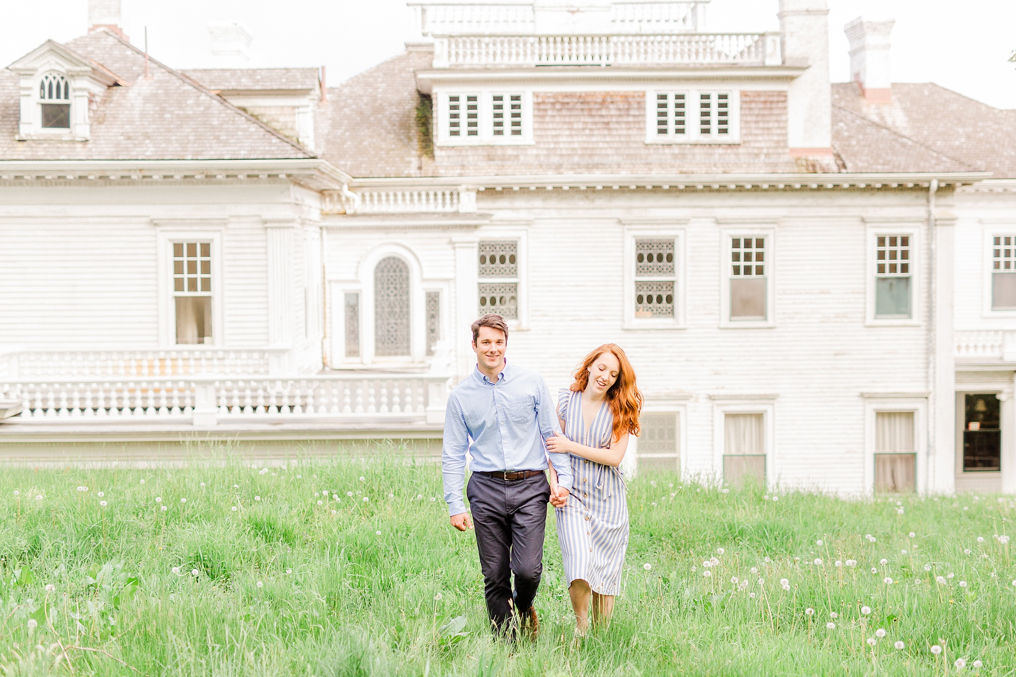 engaged couple walks through grass during Boone NC engagement photos
