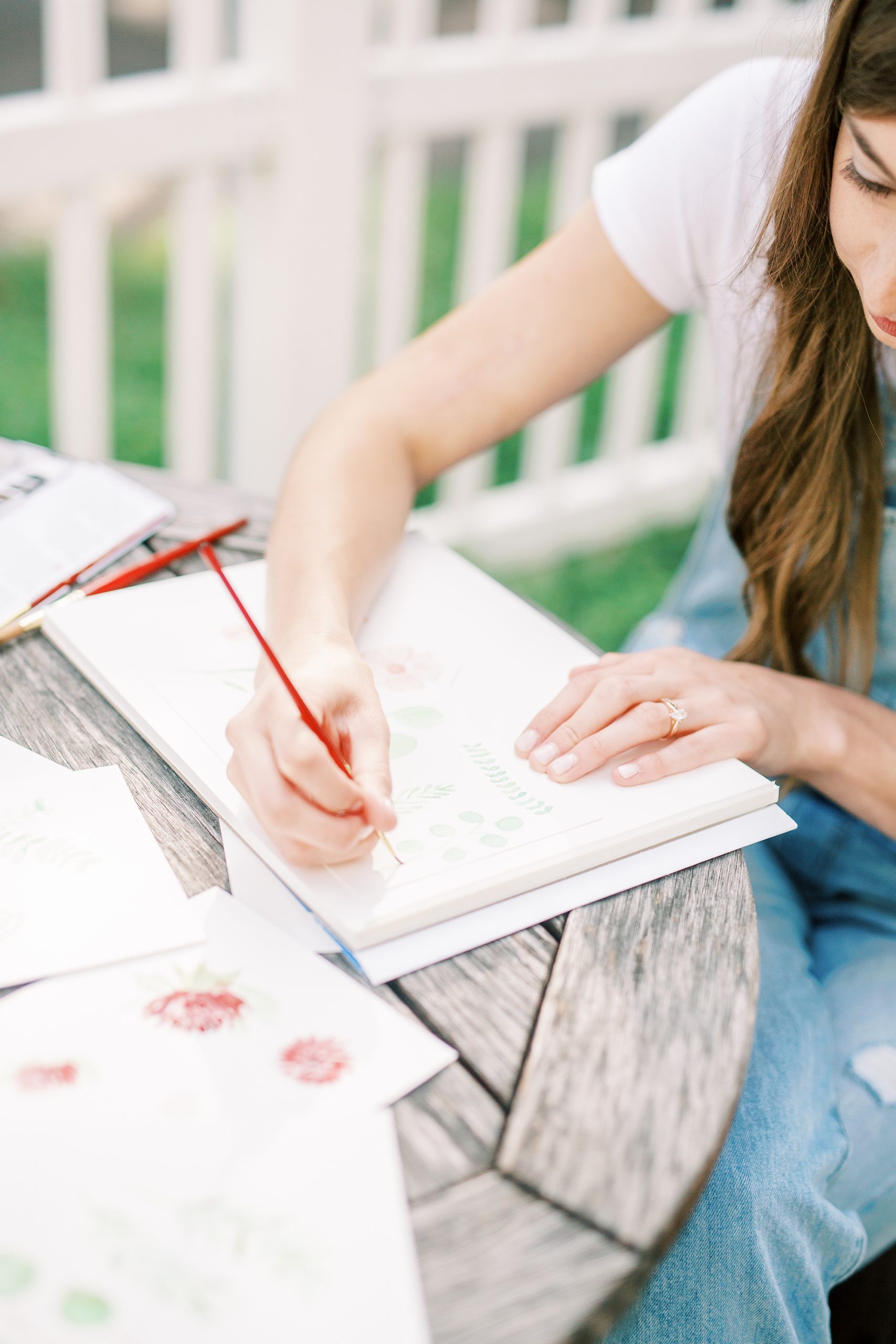 artist works on watercolor flowers during NC branding photos