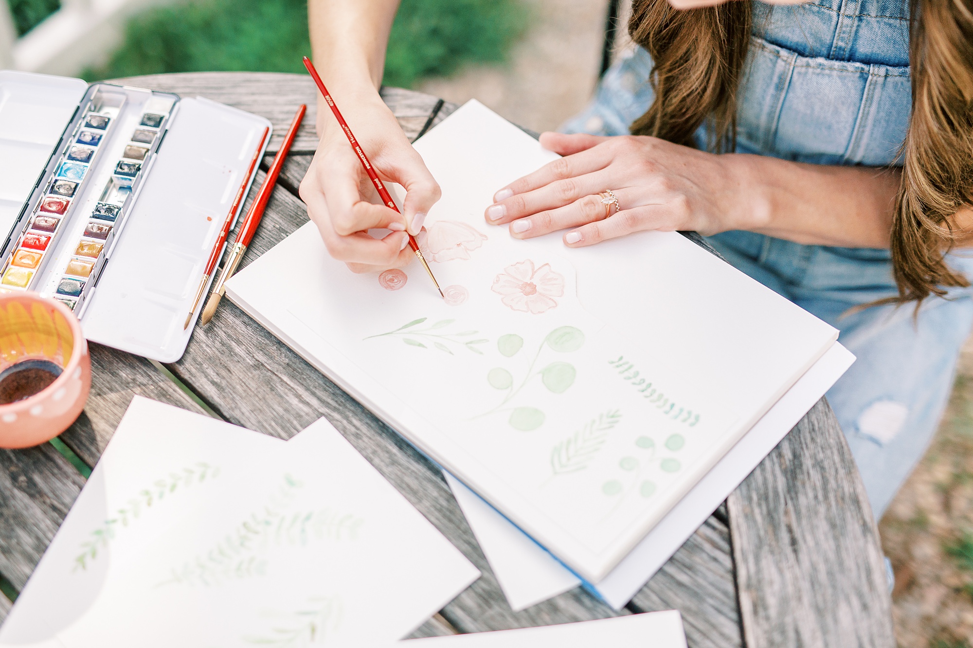 artist works on design during branding photos in Charlotte NC