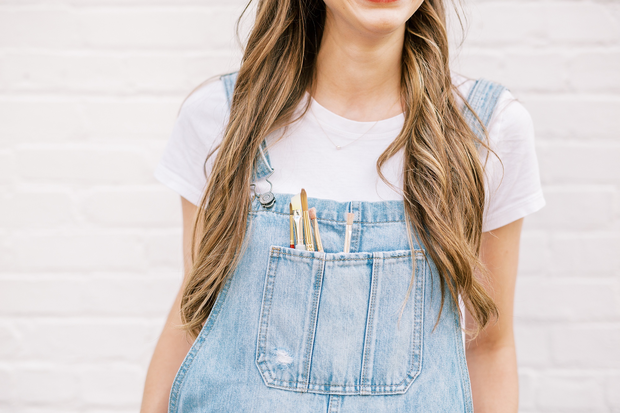 North Carolina branding portraits with artist in overalls