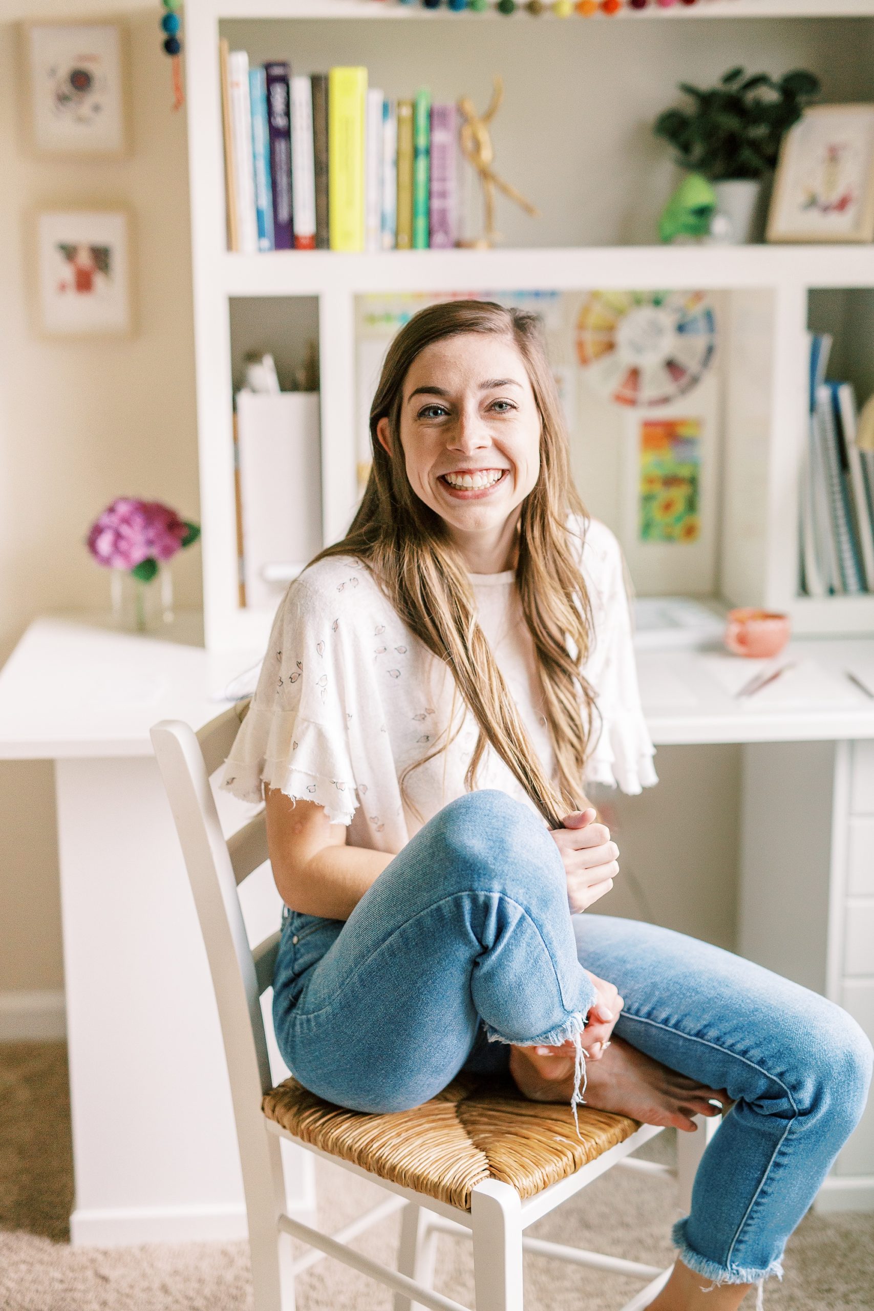 watercolor wedding invitations designer poses in home office during NC branding session
