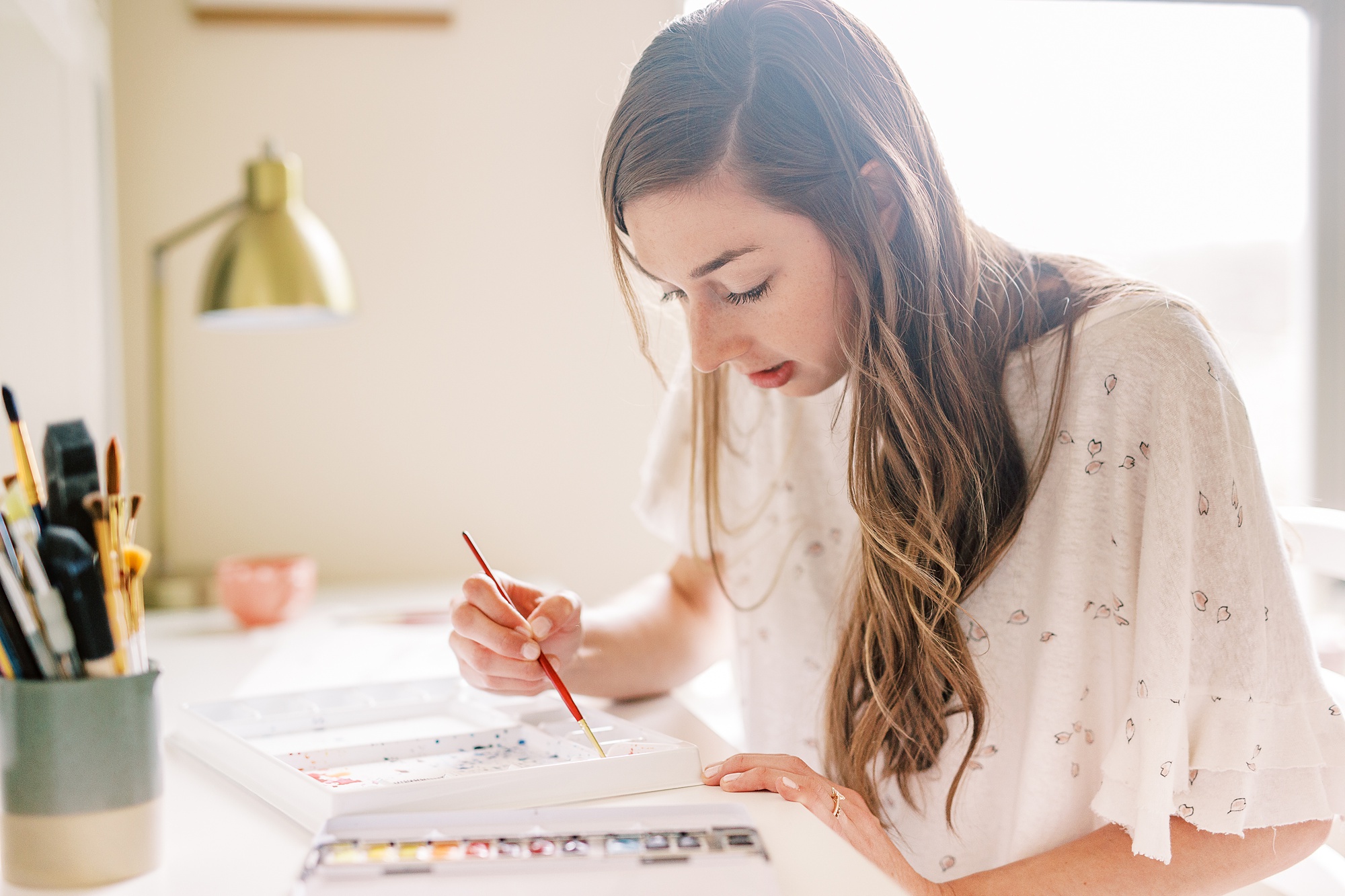 watercolor wedding invitations designer works during branding photos at home