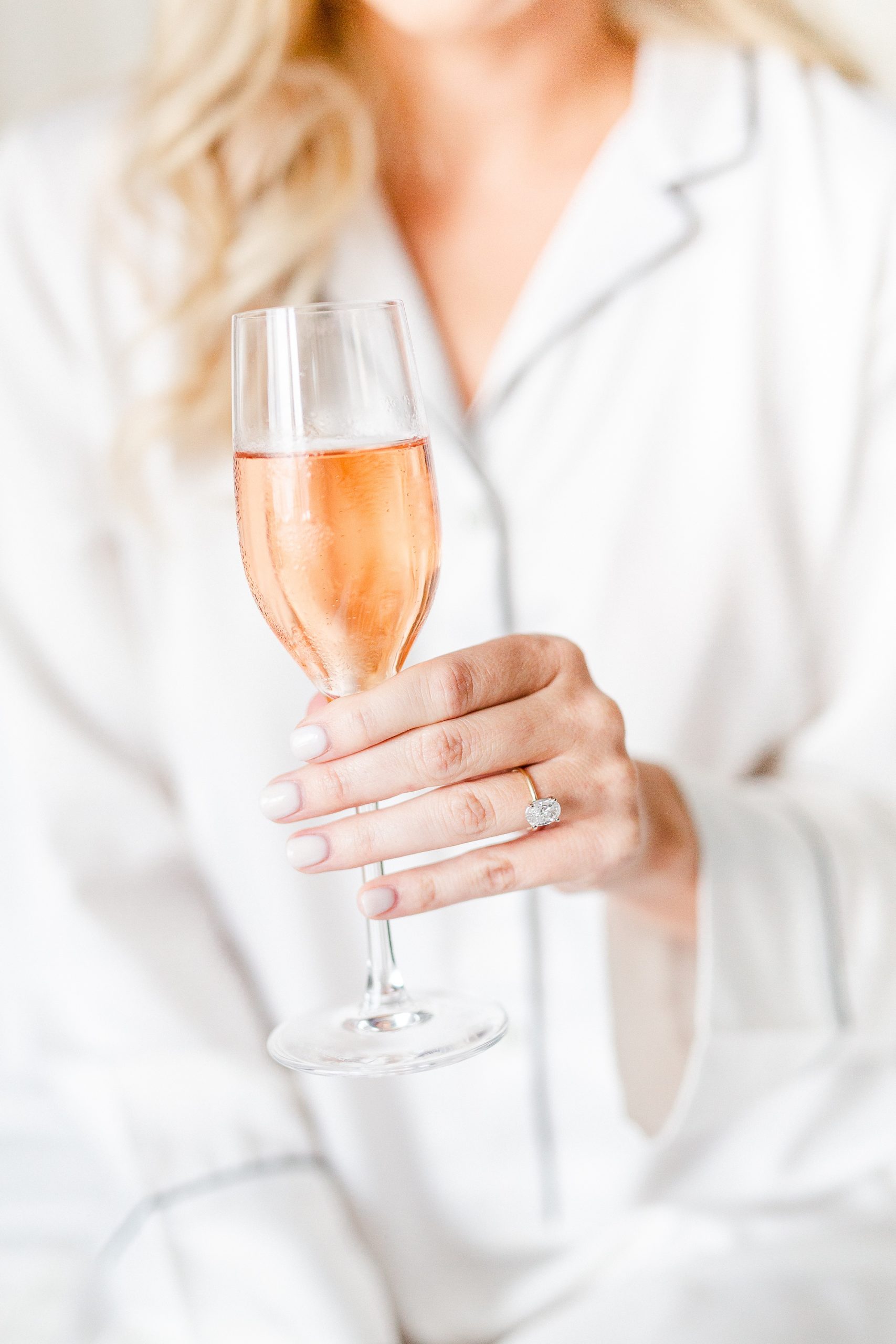 bride holds glass of champagne