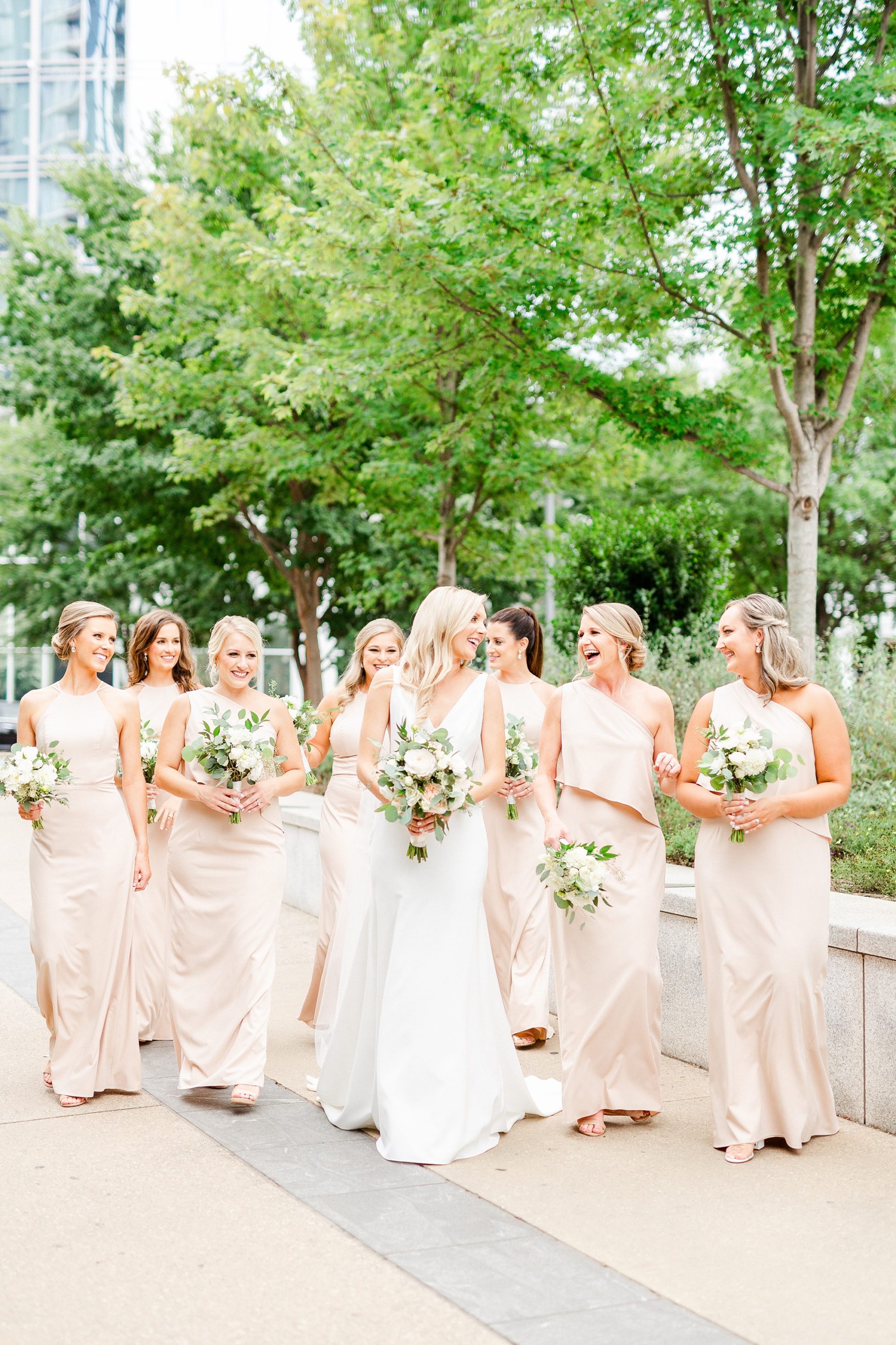 bridesmaids walk with bride at Romare Bearden Park