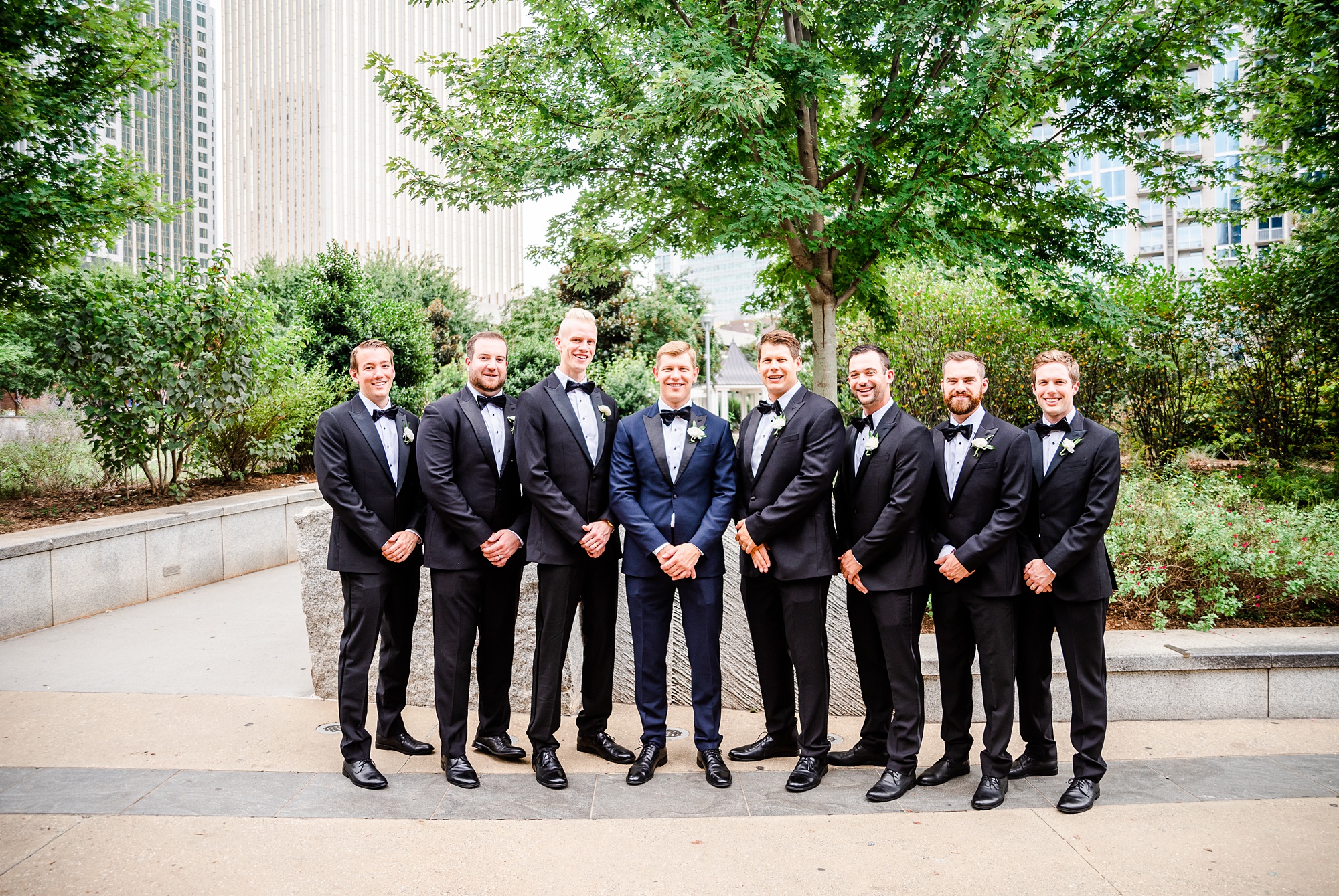 groomsmen pose with groom at Romare Bearden Park