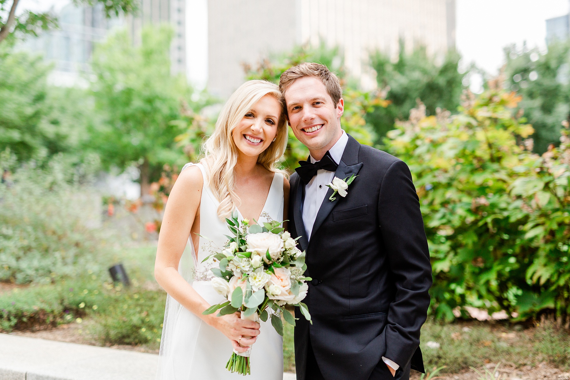 bride and brother pose together during photos on wedding day