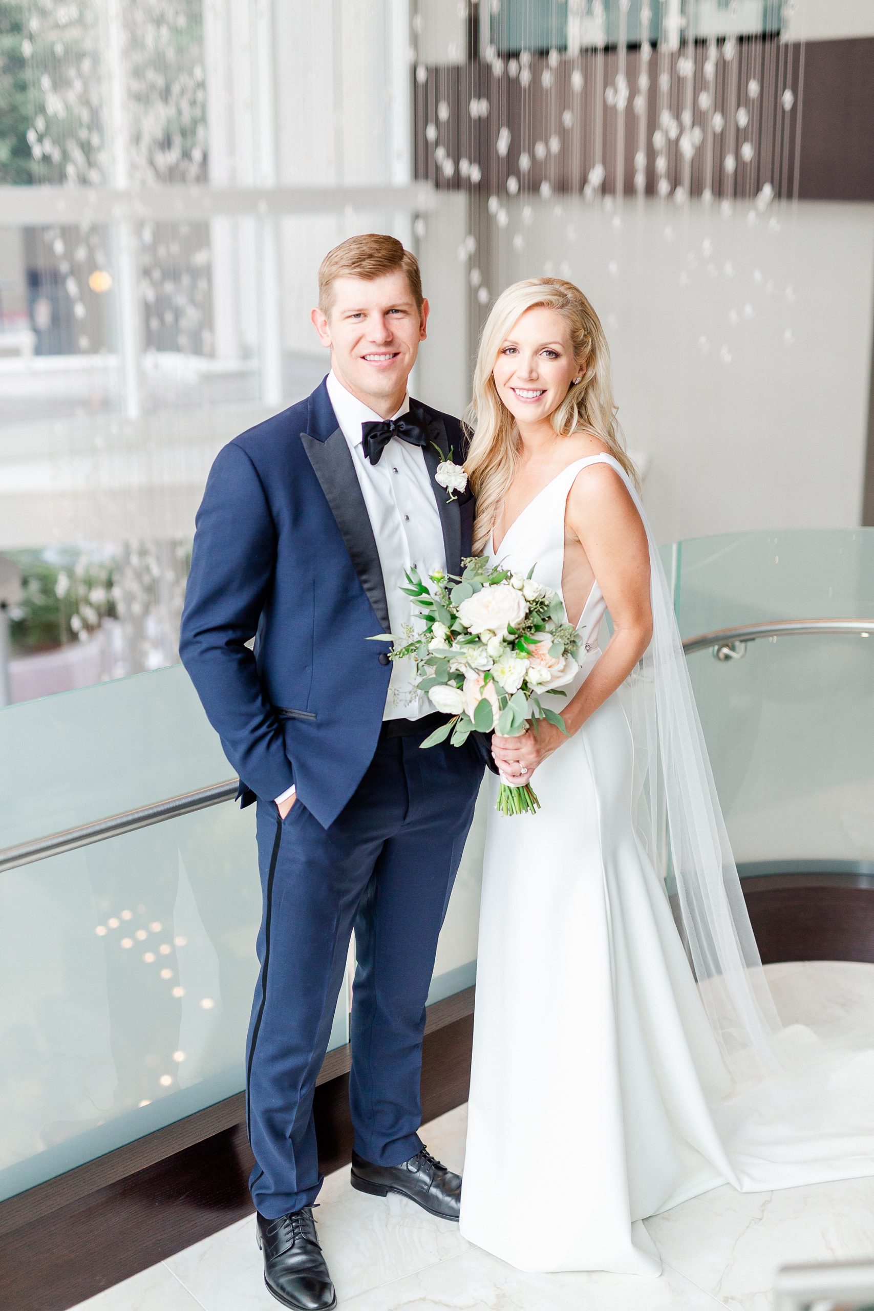 newlyweds pose on steps at Kimpton Hotel