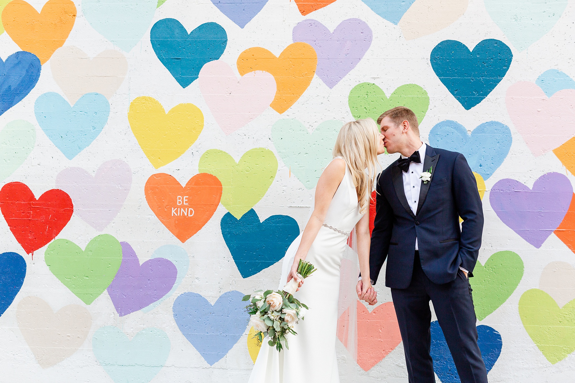 wedding portraits outside heart mural near Byron's South End