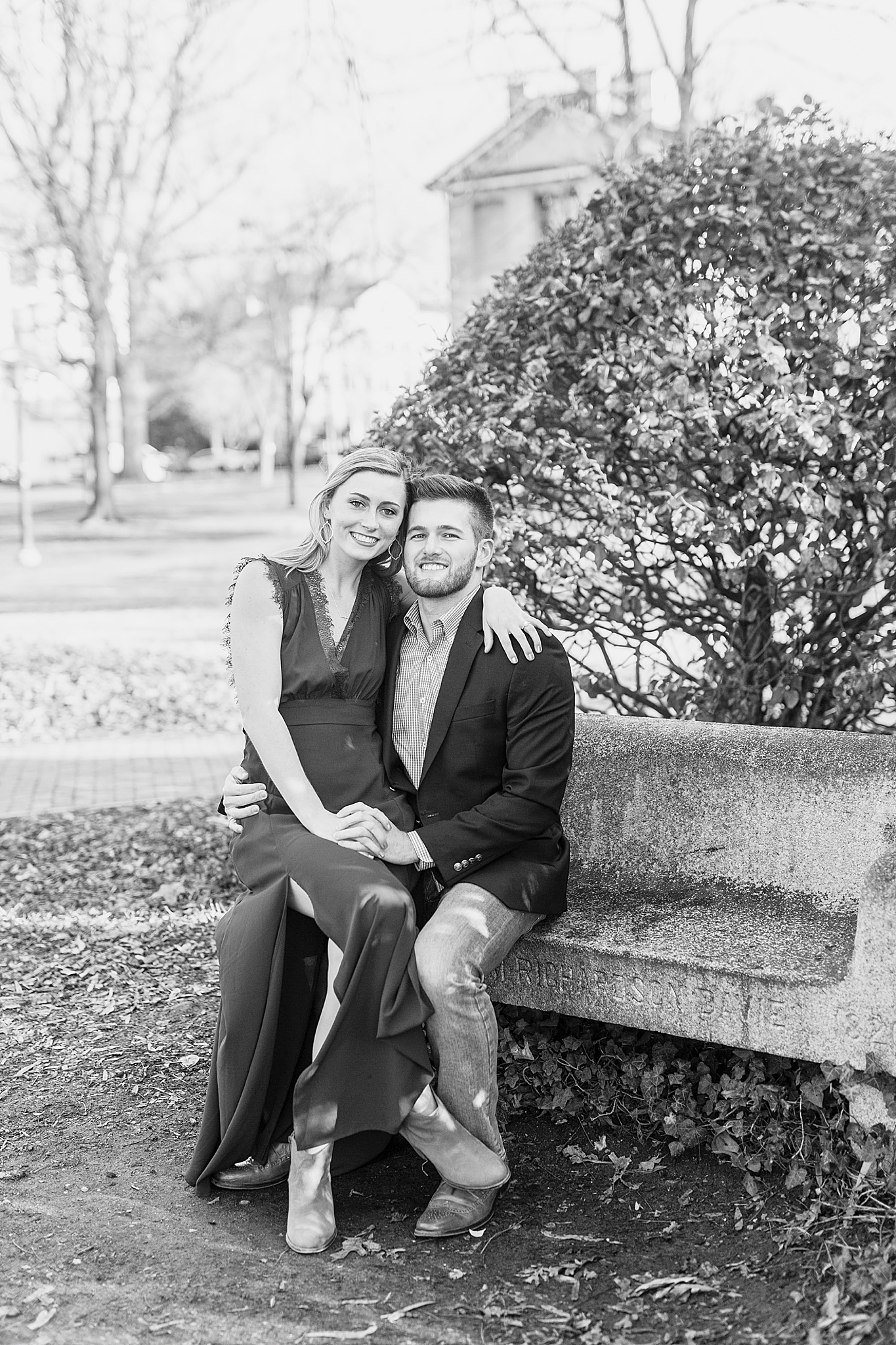 bride and groom sit on bench in downtown Chapel Hill
