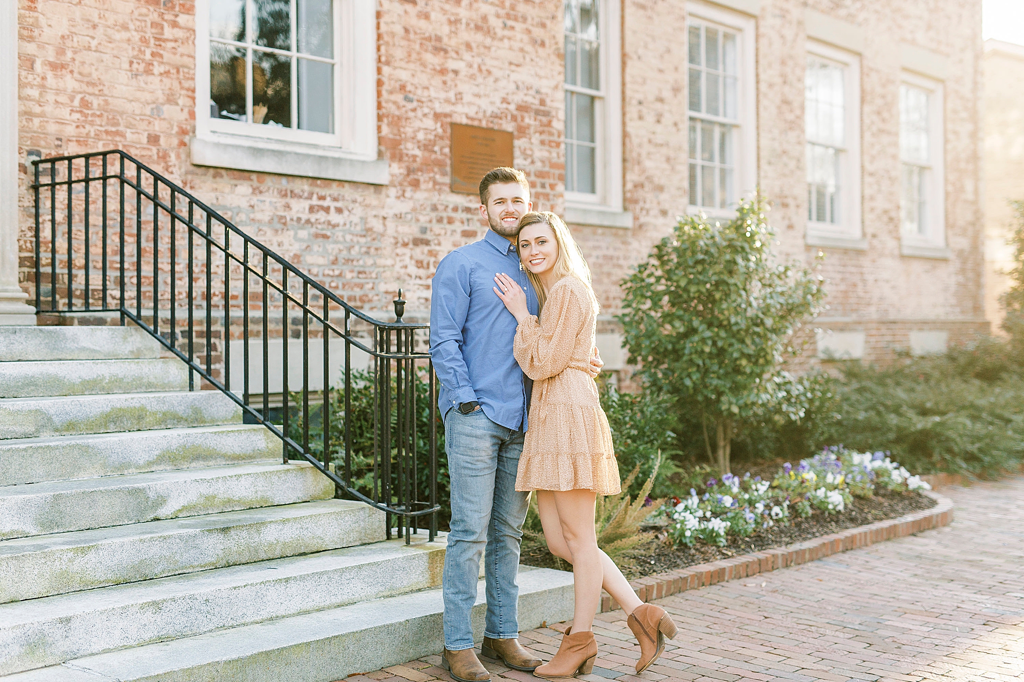 bride and groom pose outside brick building on Chapel Hill campus