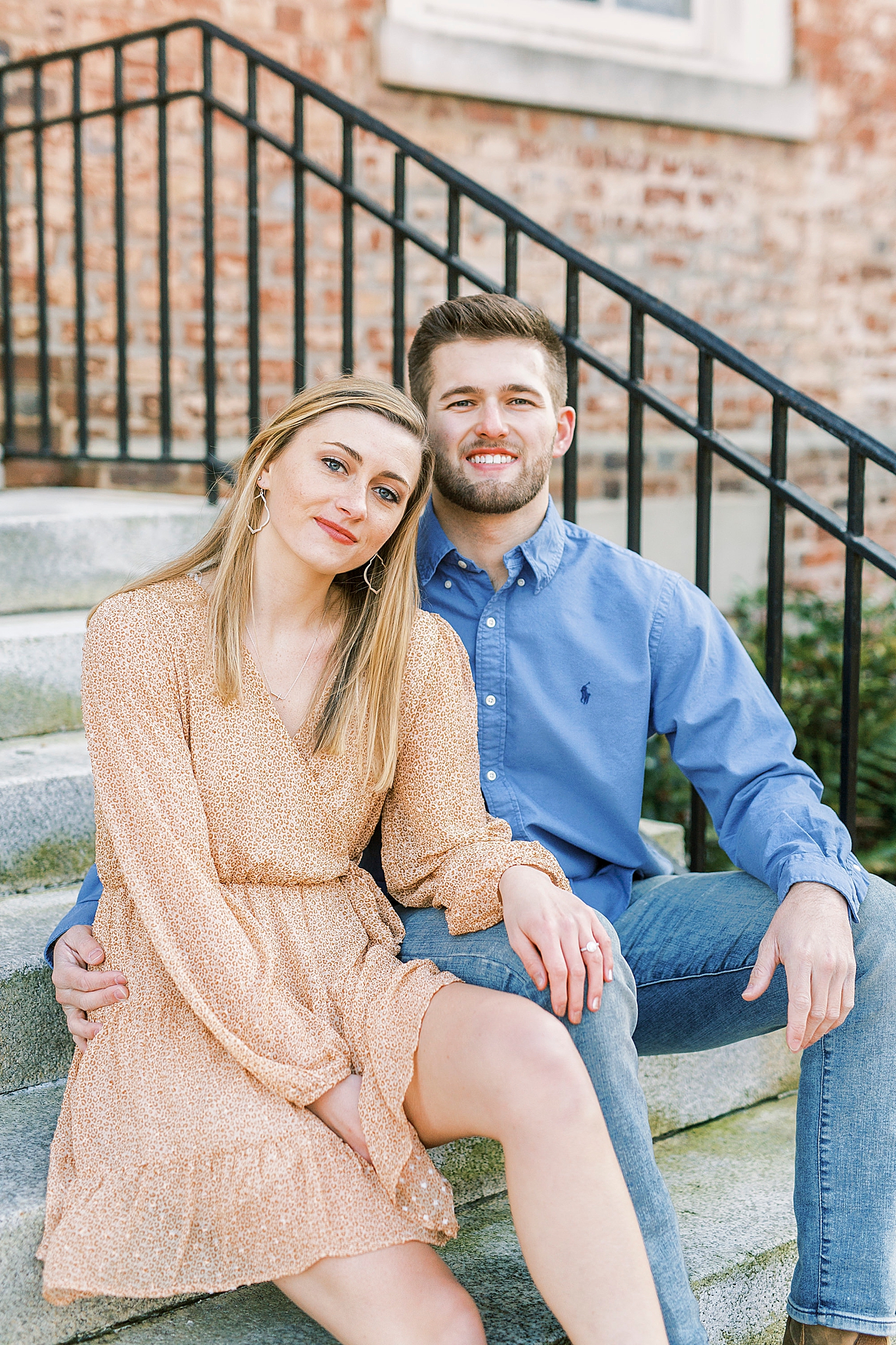 bride and groom sit on steps at UNC Chapel Hill