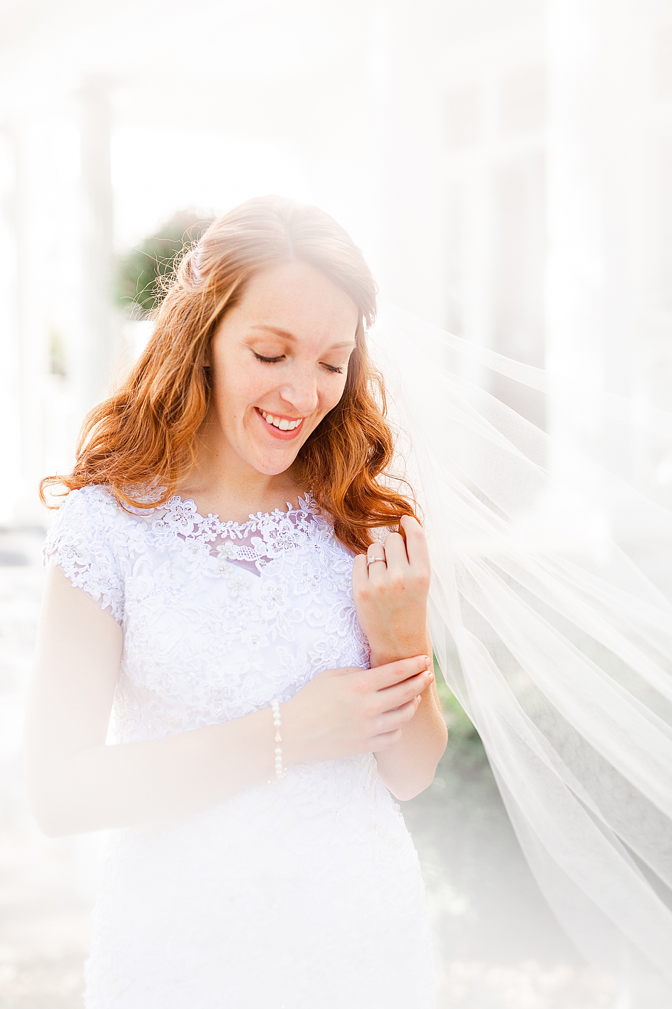 bride smiles with veil draped around her