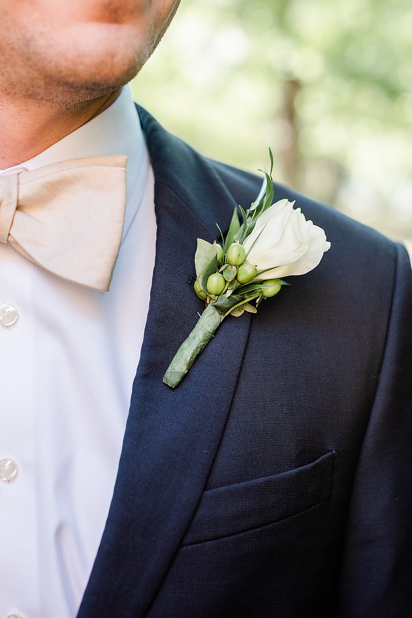 groom with ivory boutineere