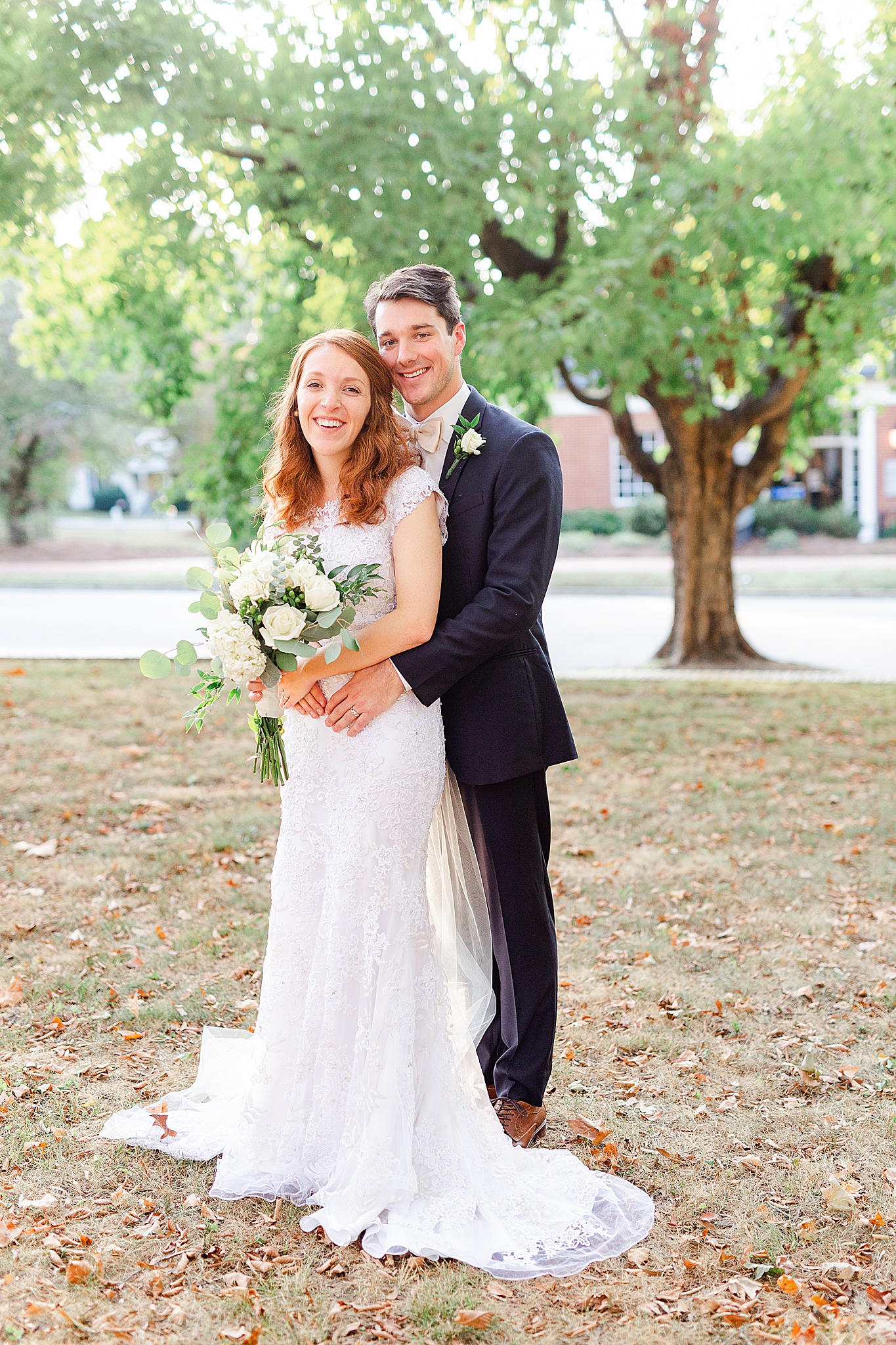 groom hugs bride from behind during NC wedding photos