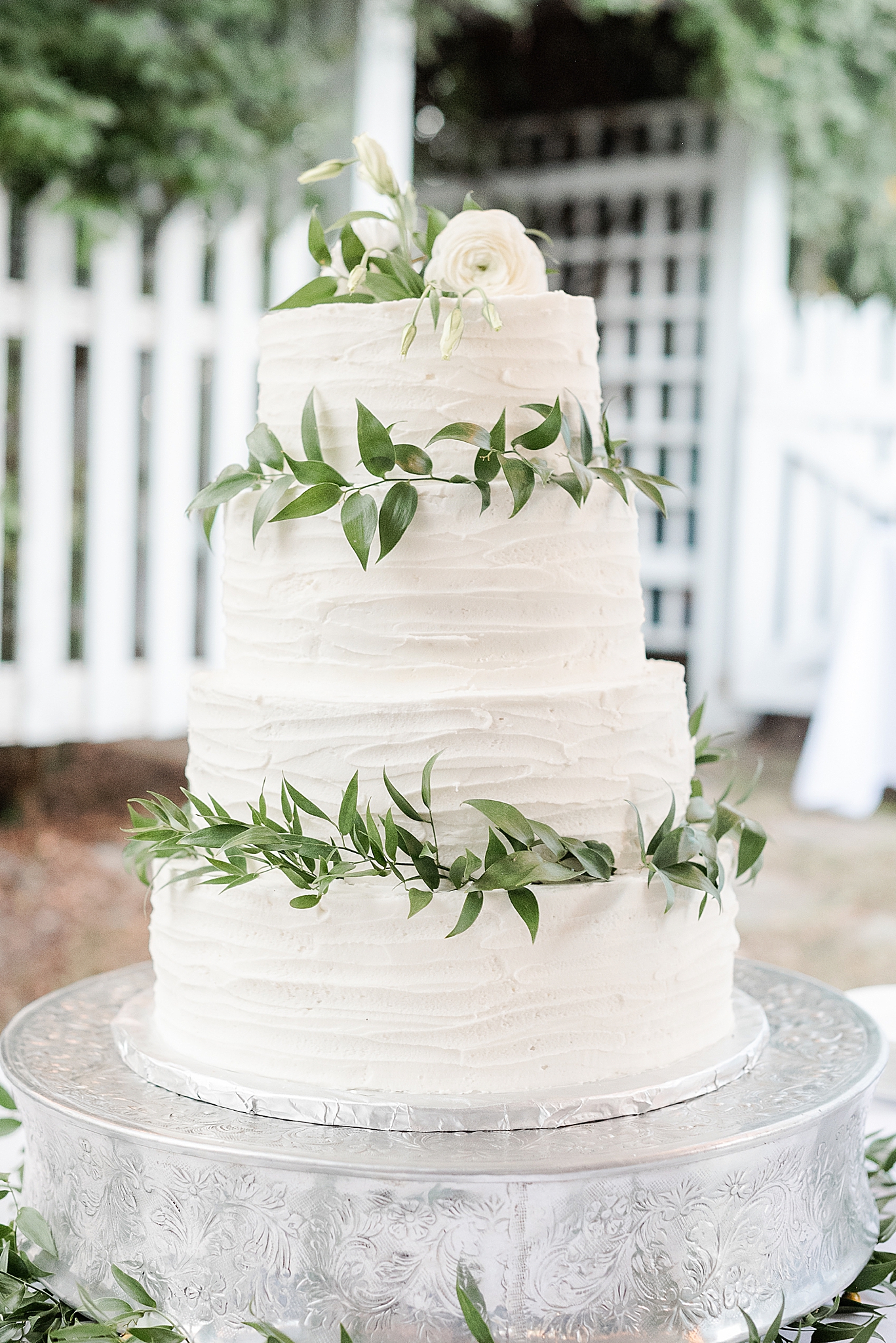 tiered wedding cake with elegant greenery