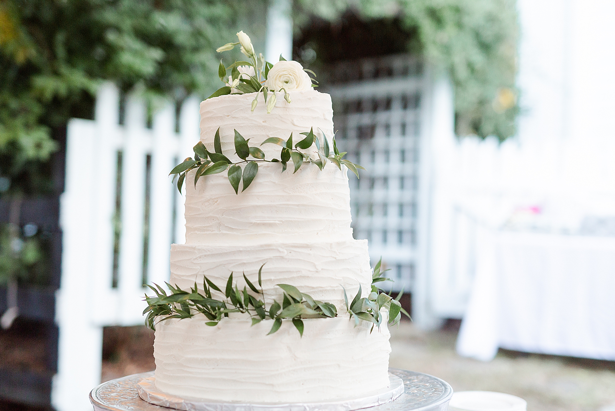 wedding cake with wreaths of greenery