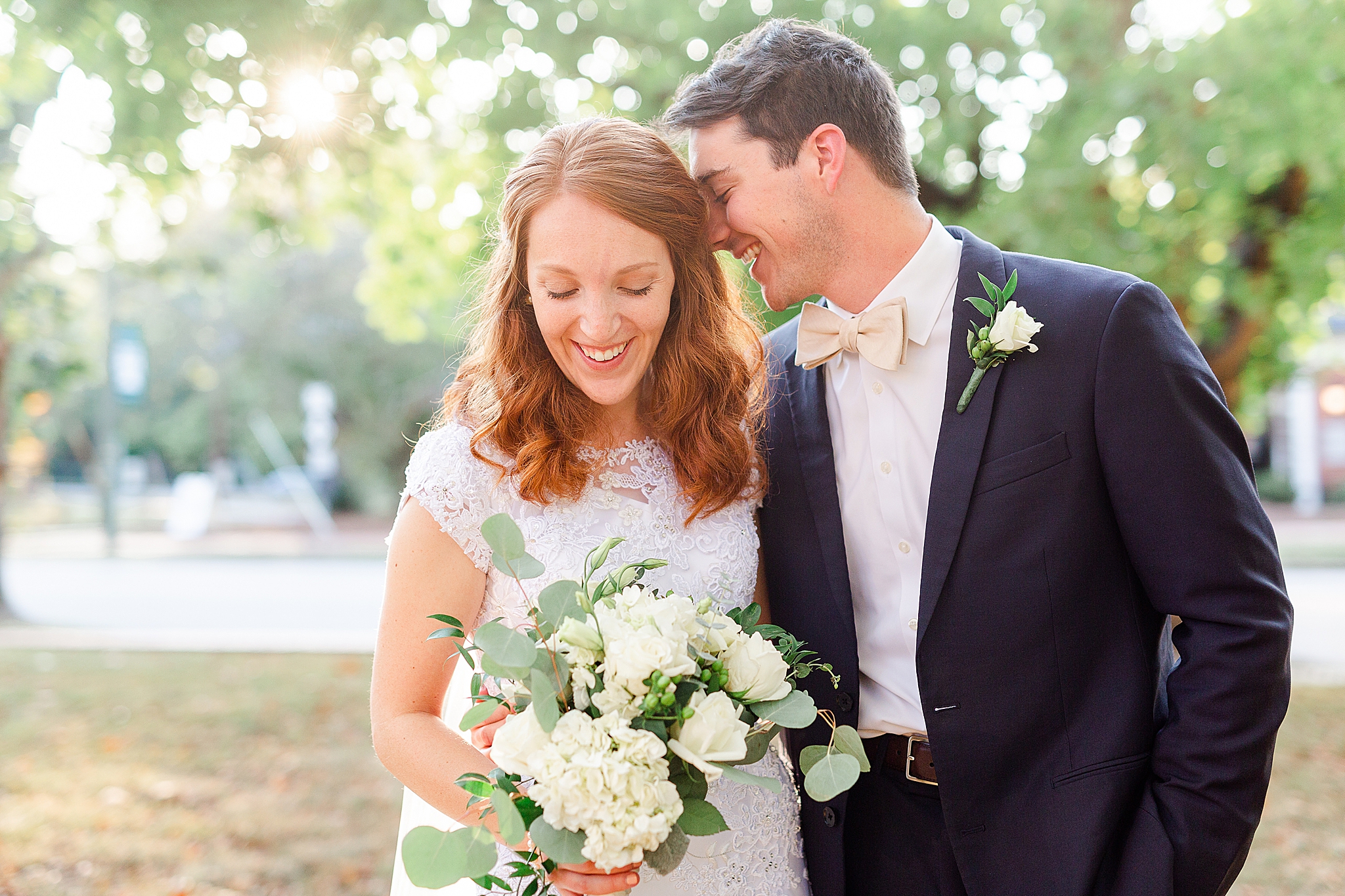 groom nuzzles bride's hair during wedding photos