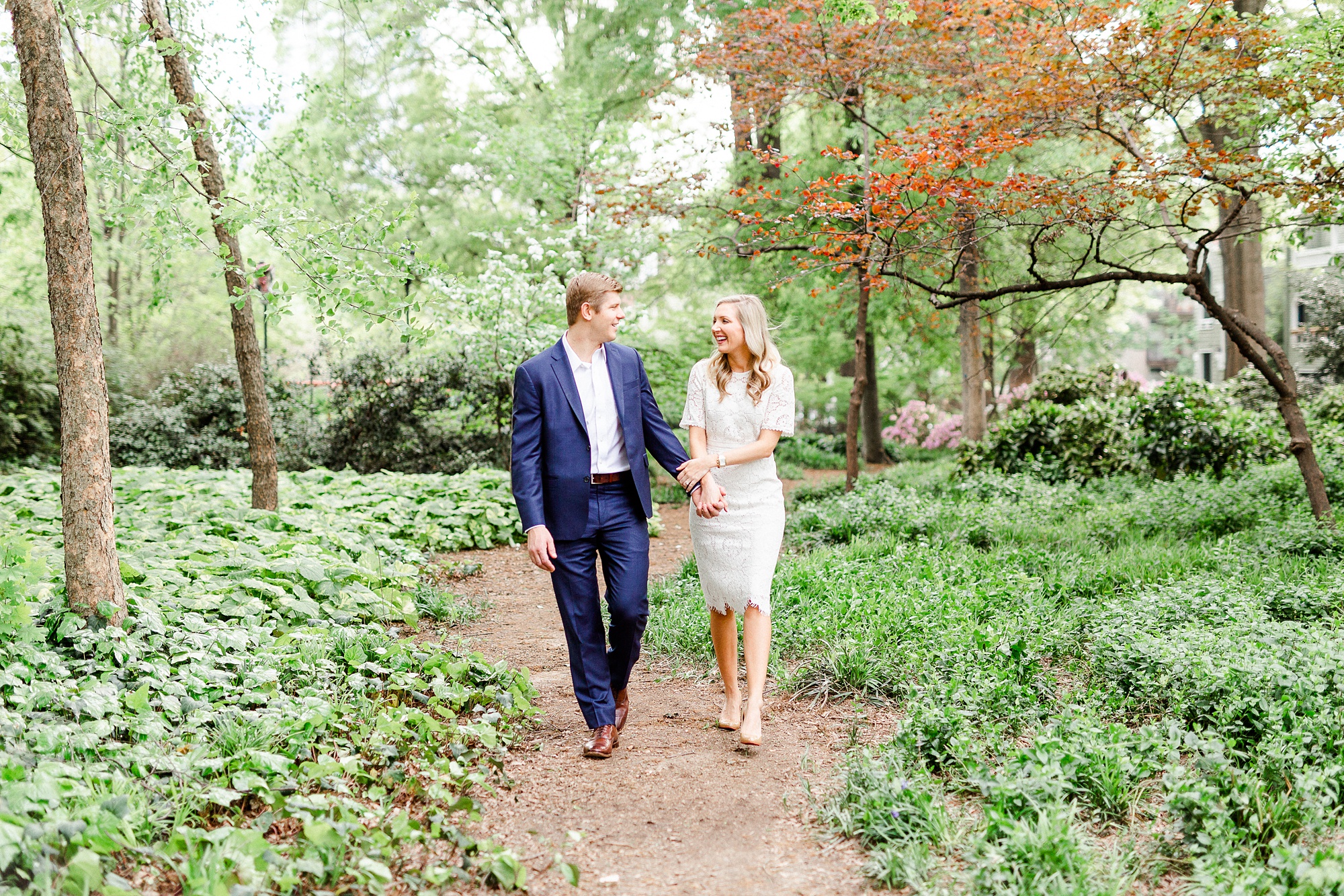 engaged couple walks through Fourth Ward Park in Charlotte NC