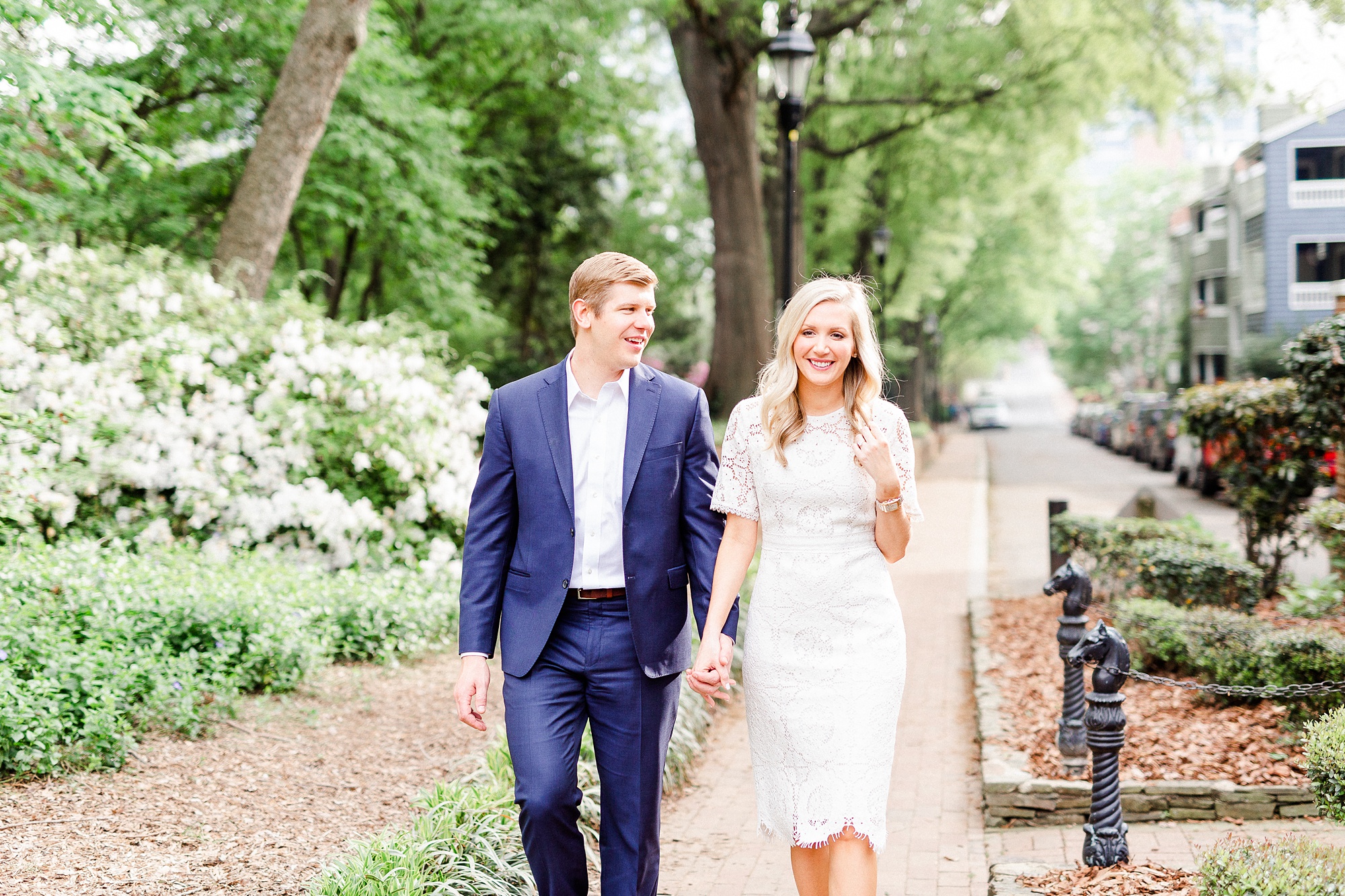 engaged couple walks through parks in Charlotte NC