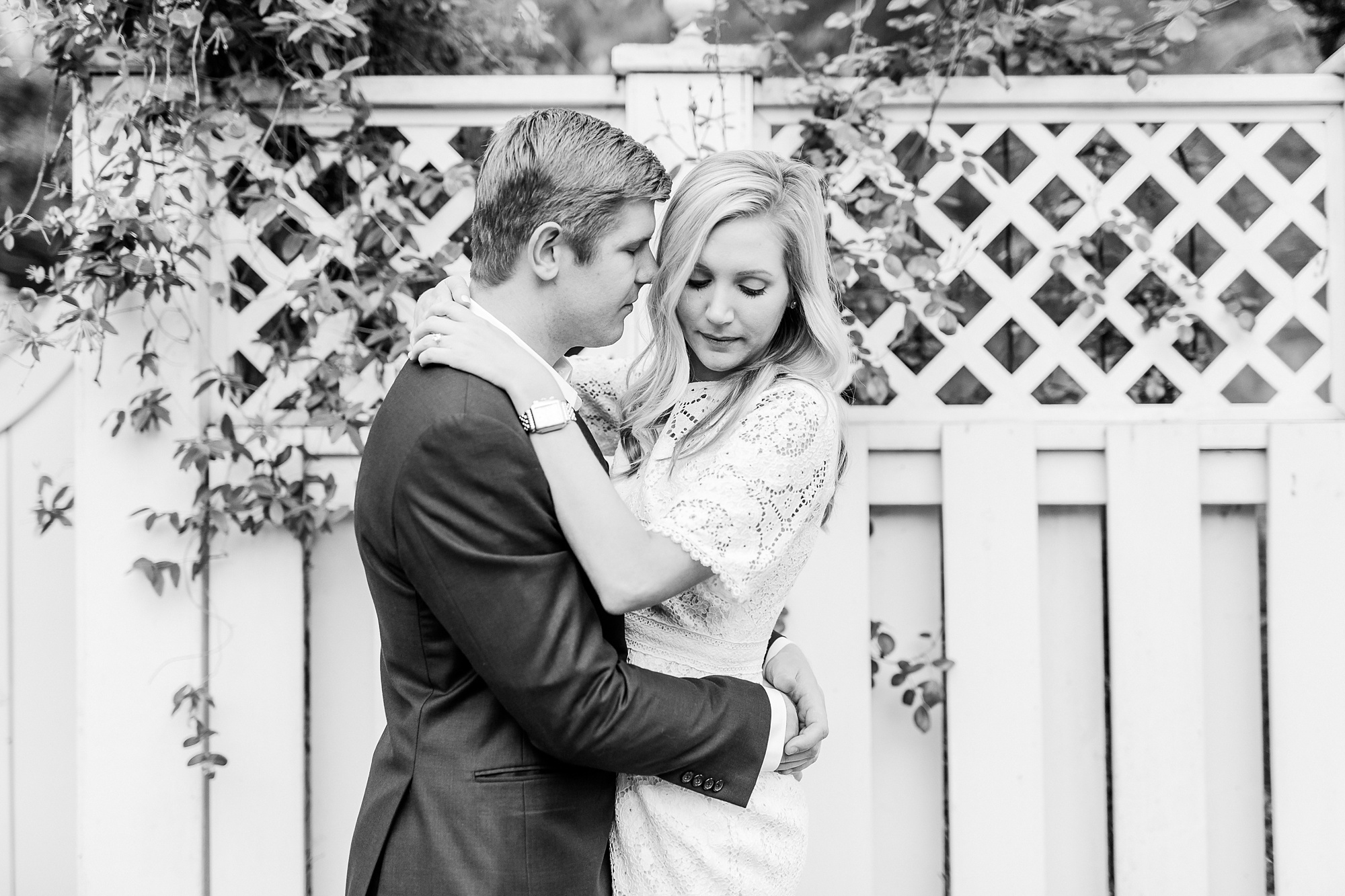 stylish Charlotte engagement photos along white fence