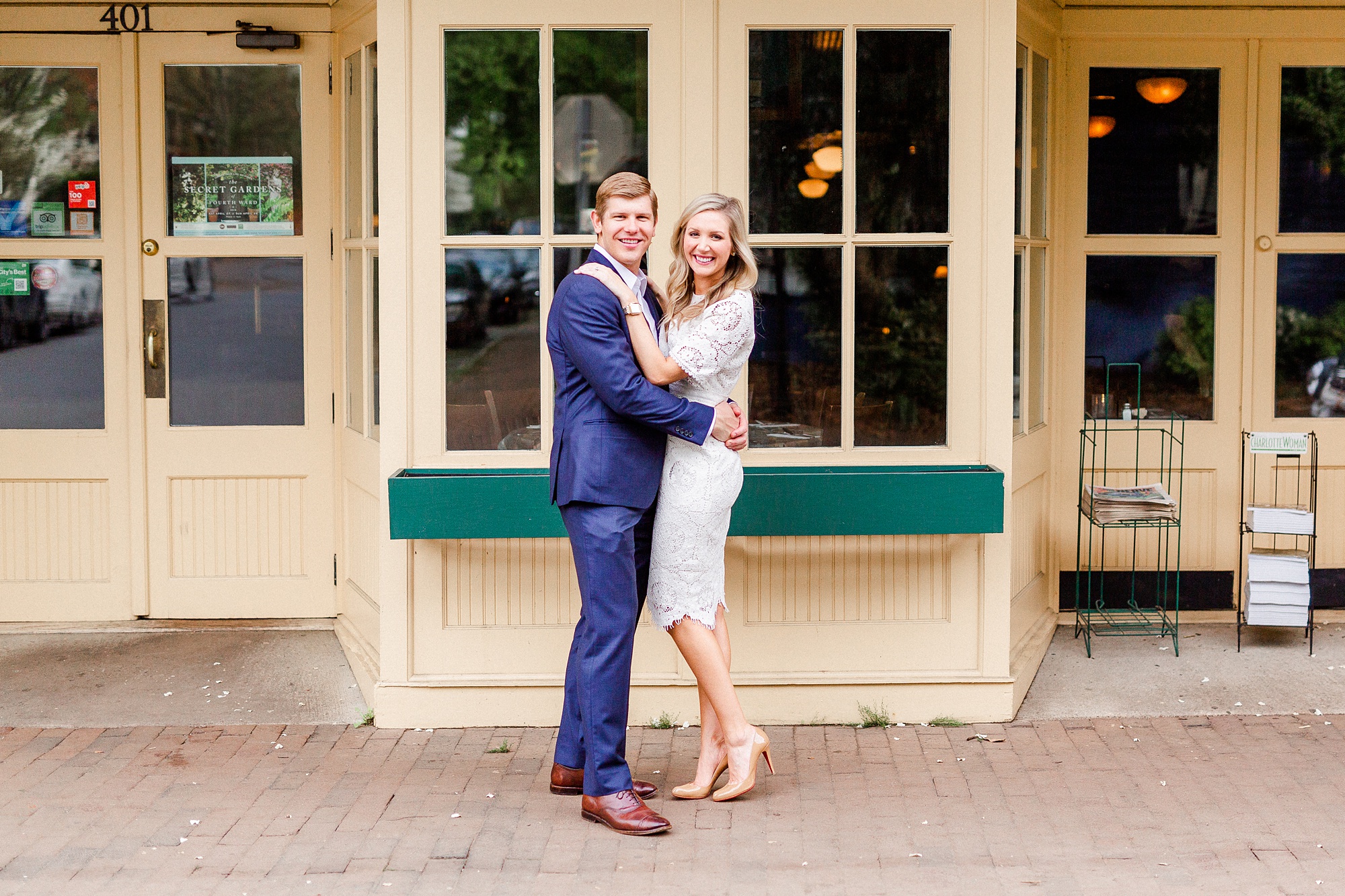 bride and groom pose by Charlotte restaurant