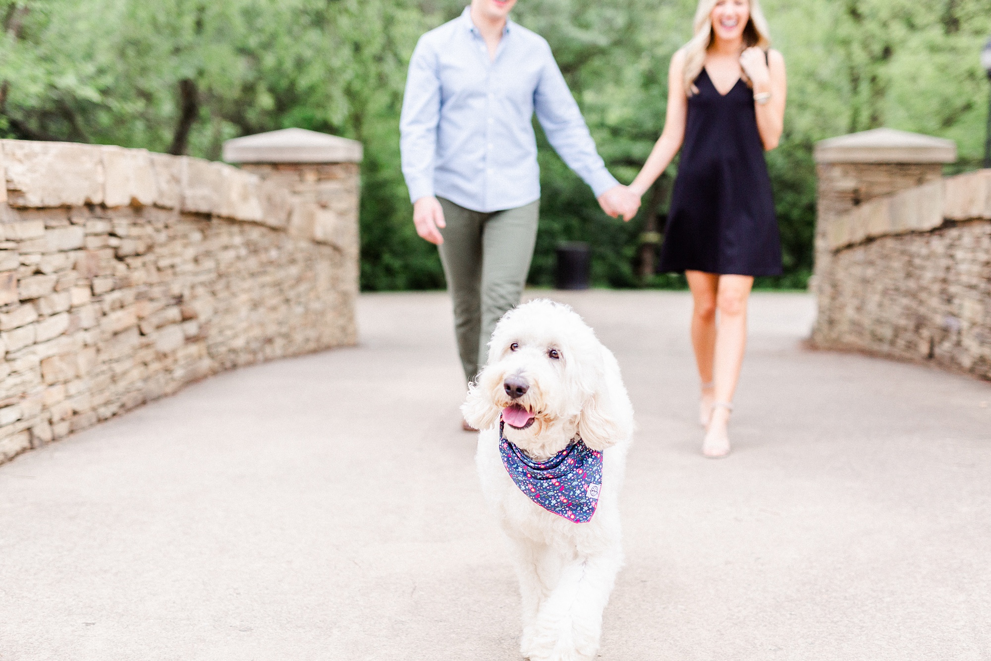 couple walks dog over the bridge at Freedom Park
