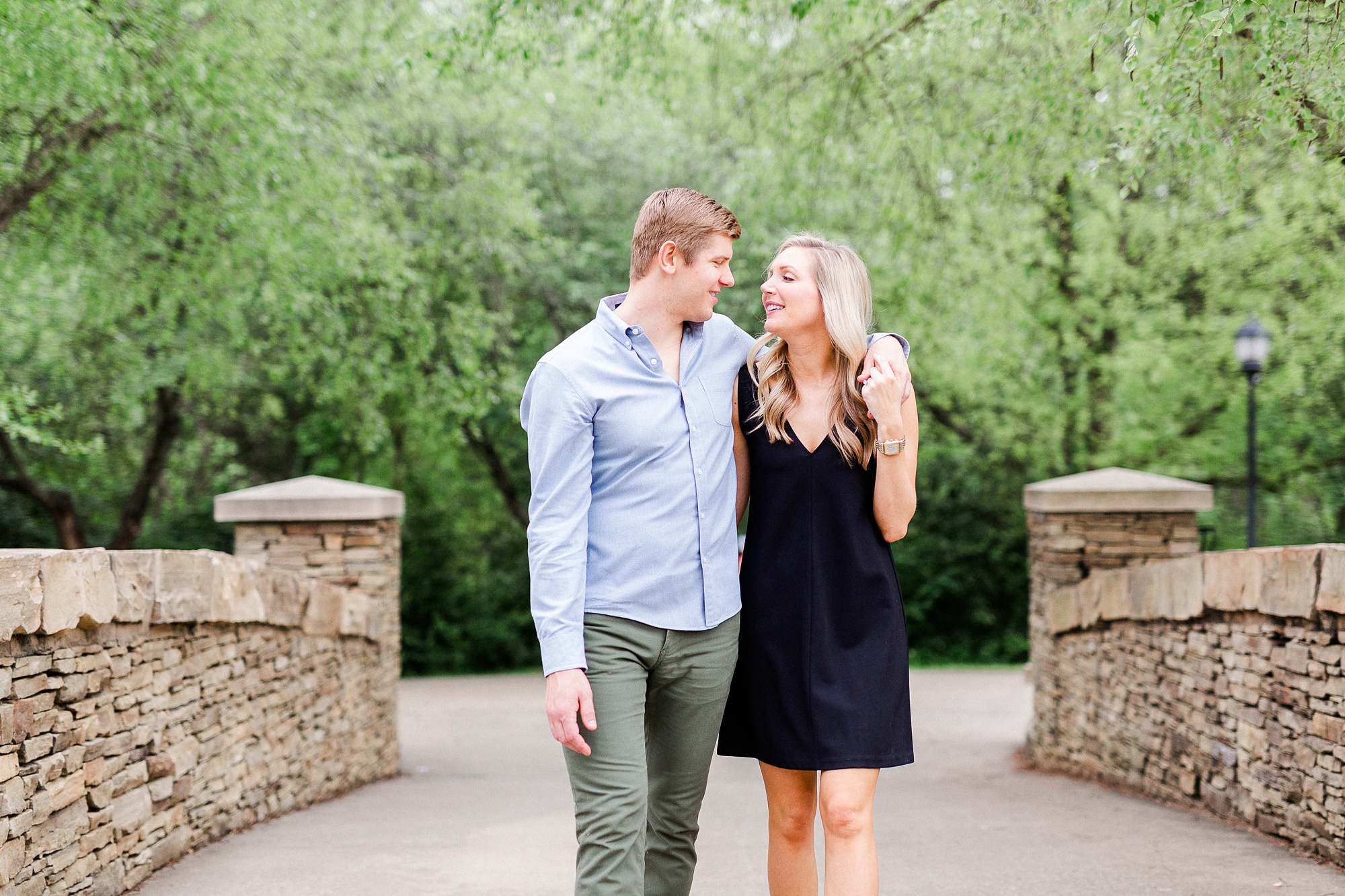 engaged couple walks along bridge in Charlotte NC