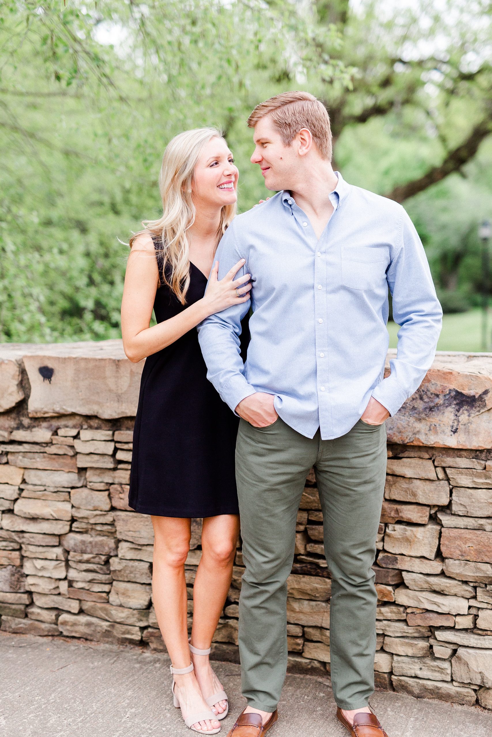 stylish Charlotte engagement photos on bridge in Freedom Park