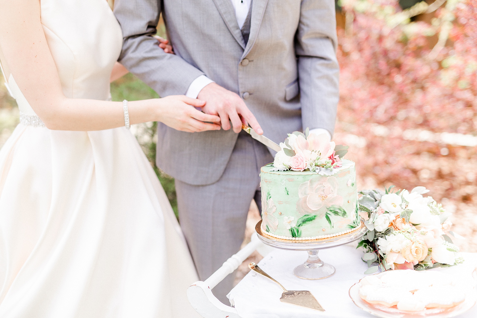 bride and groom cut wedding cake at NC wedding reception