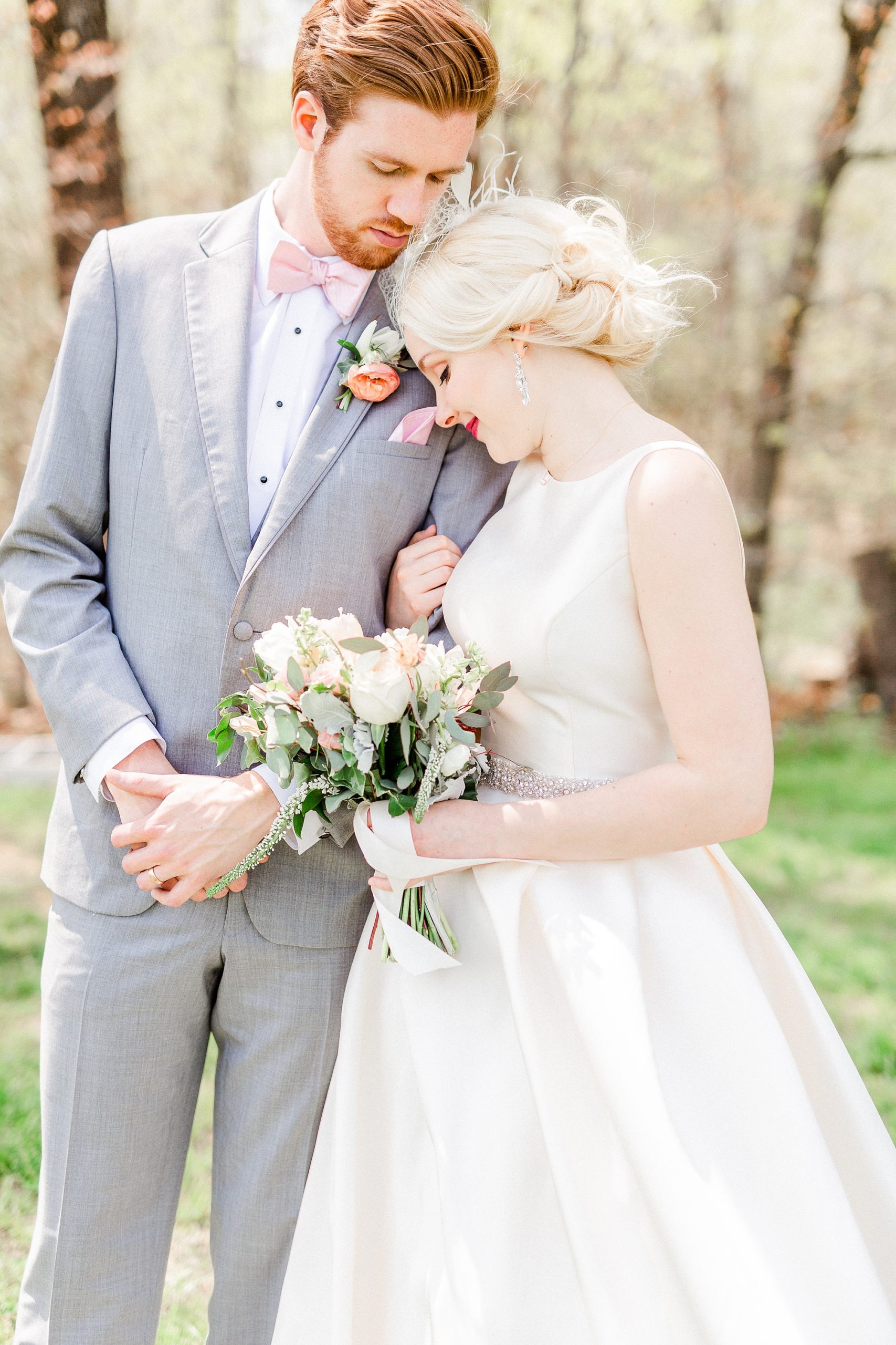 bride leans head against groom's arm