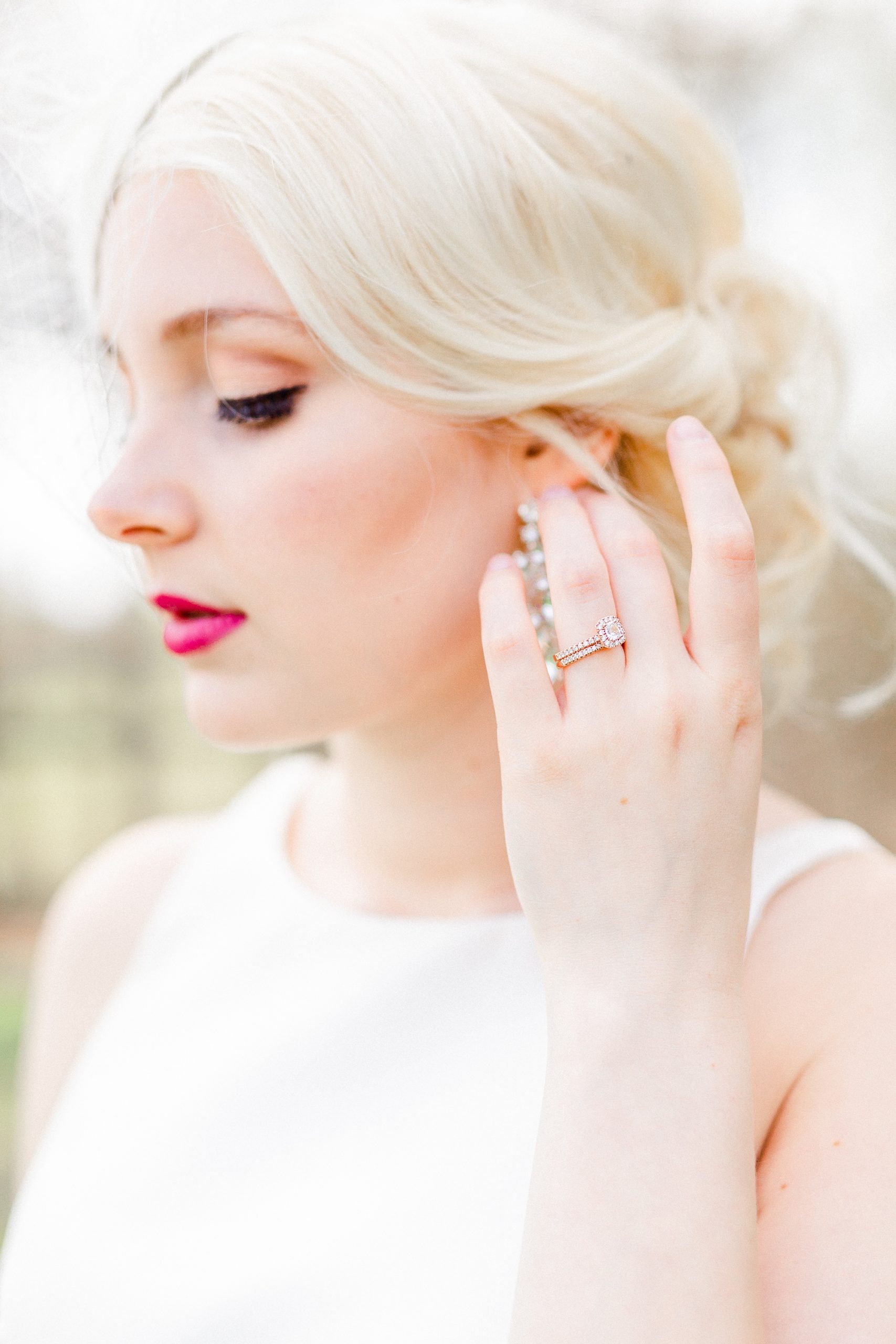 bride shows off wedding ring while pushing hair back
