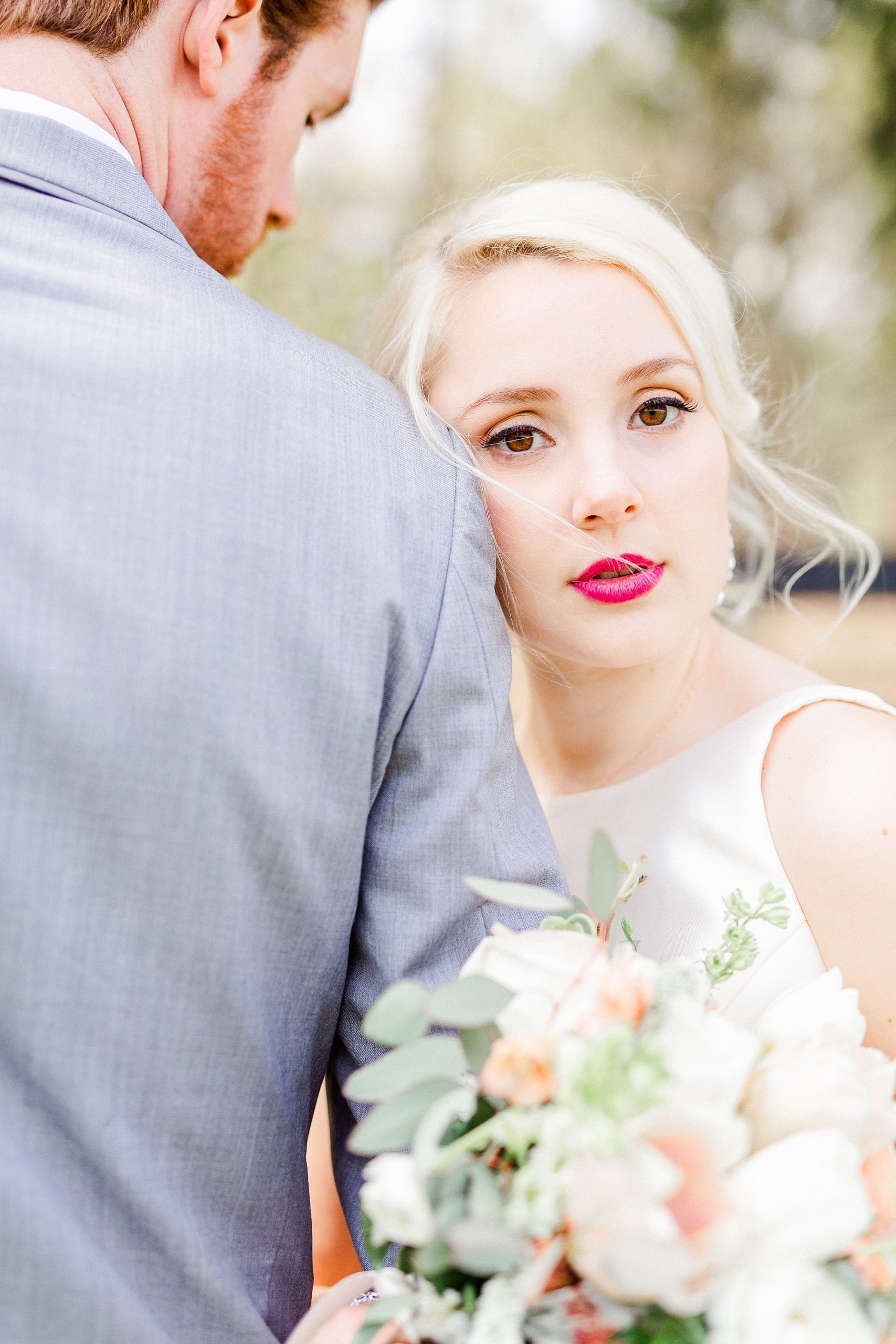 bride leans against groom's arm