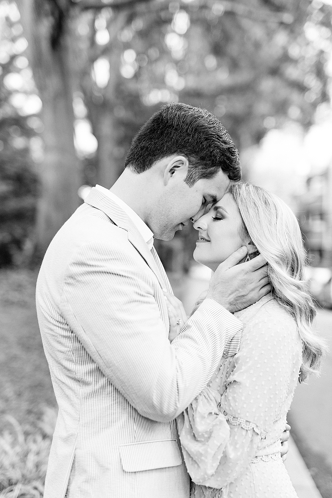 bride and groom stand nose to nose in Fourth Ward Park