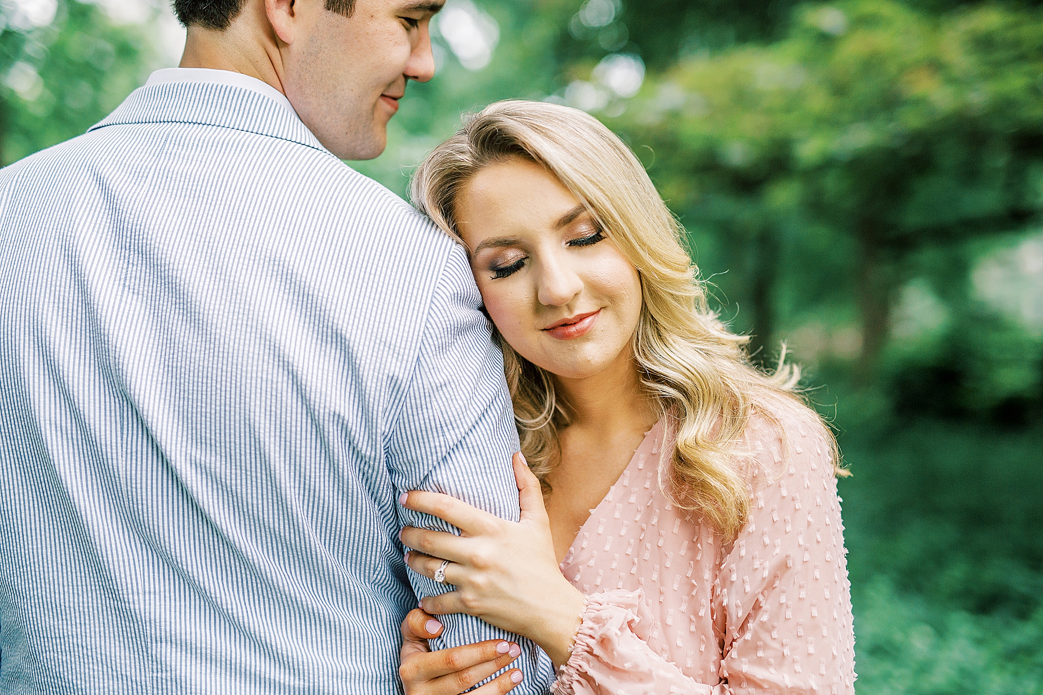 bride leans against groom's arm in Fourth Ward Park