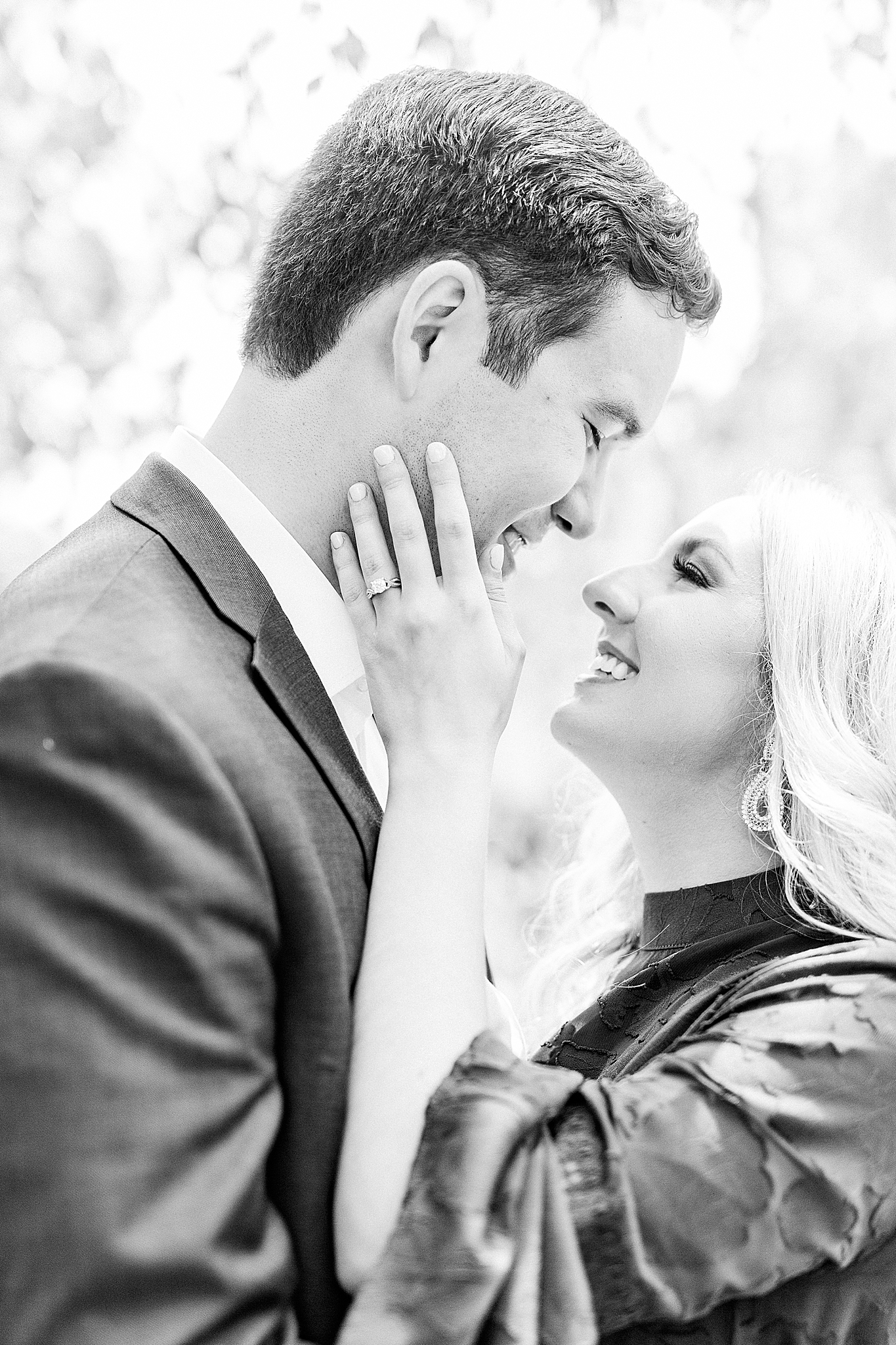 bride looks up at groom in Freedom Park holding his chin