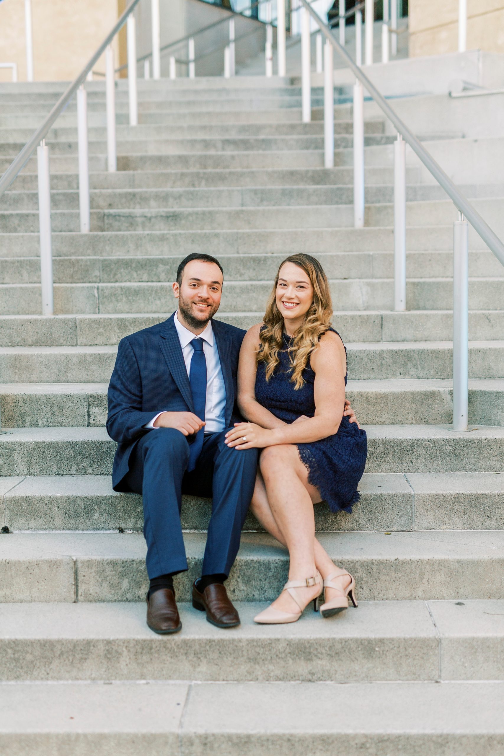 springtime Mint Museum engagement session with couple in navy blue