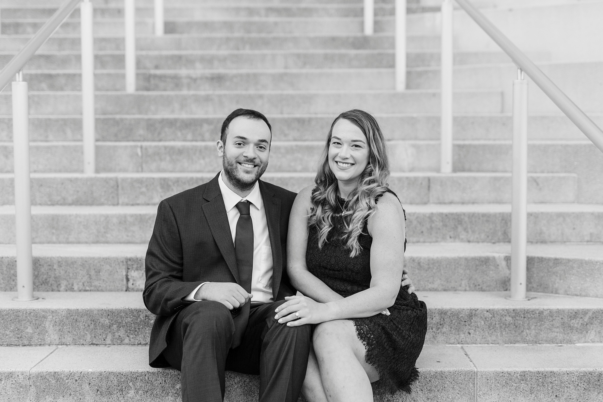 engaged couple sits on steps at Mint Museum