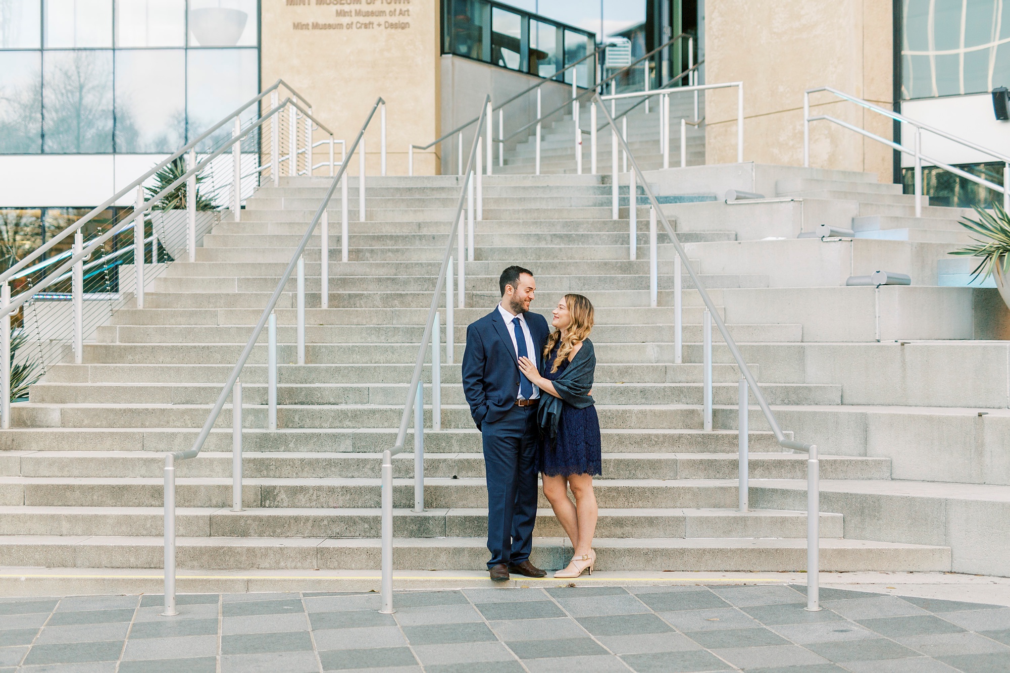 bride and groom stand on steps at Mint Museum