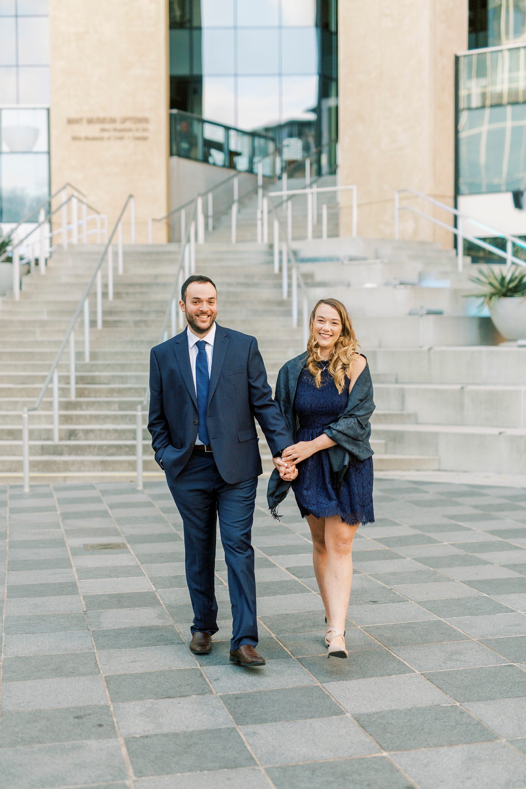 engaged couple walks in front of Mint Museum in Charlotte NC