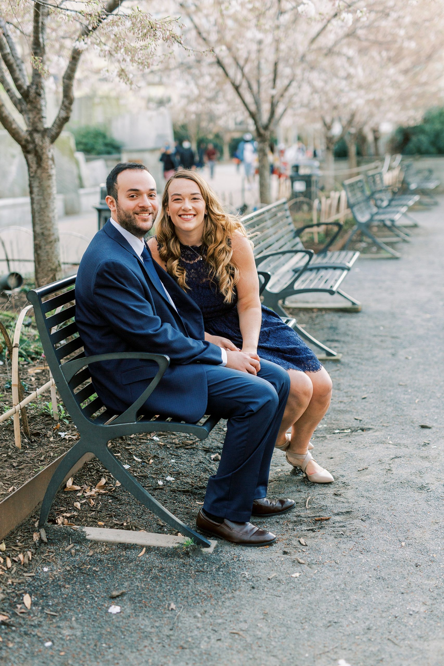 couple sits on bench in Uptown Charlotte