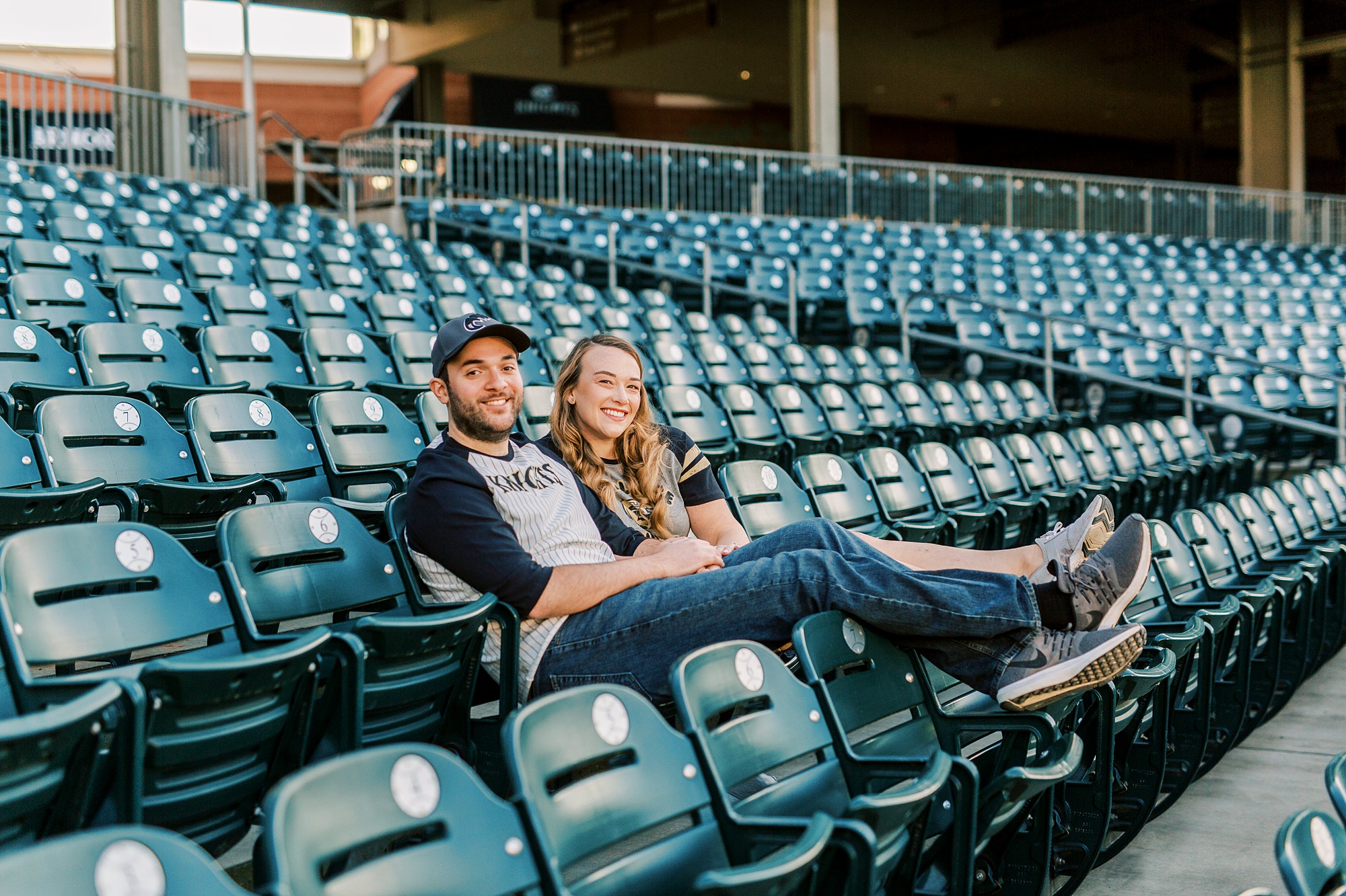 bride and groom sit on sidelines at Truist Field