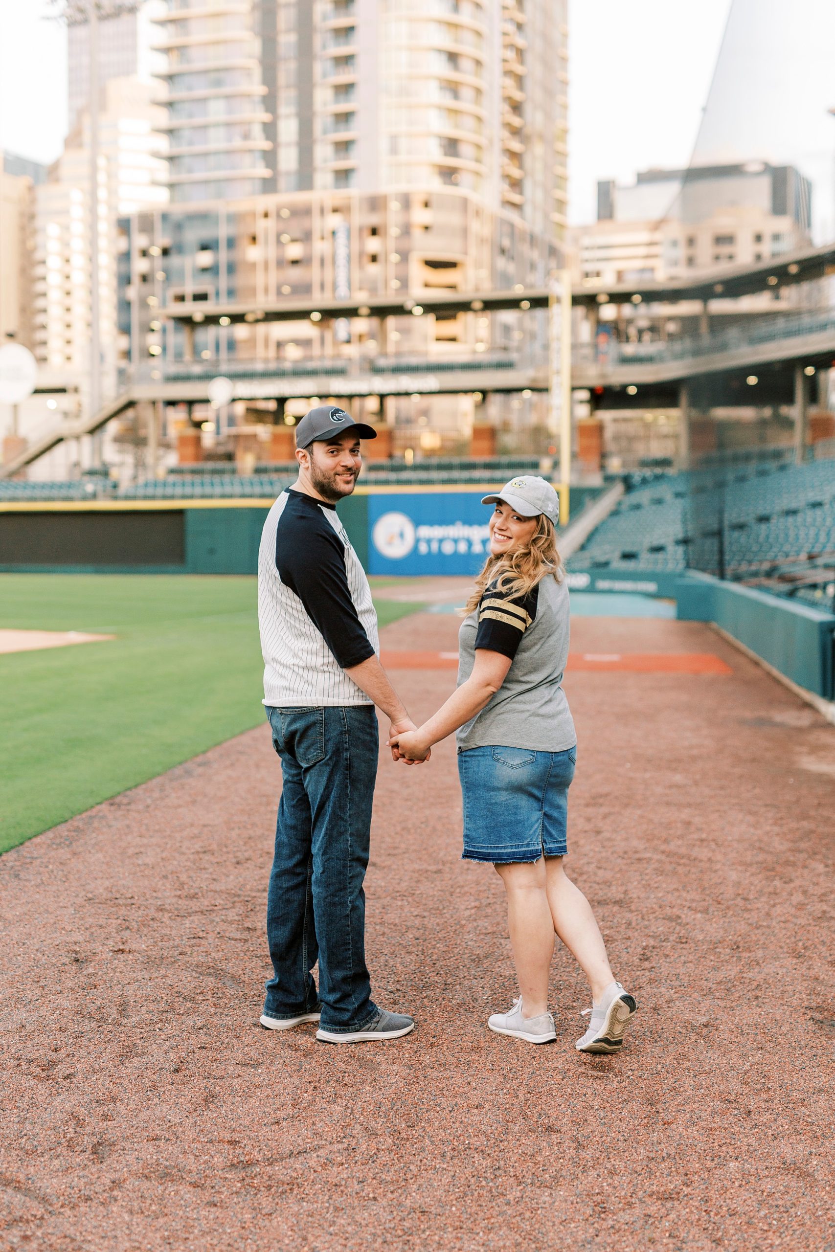 engaged couple walks inside Truist Field