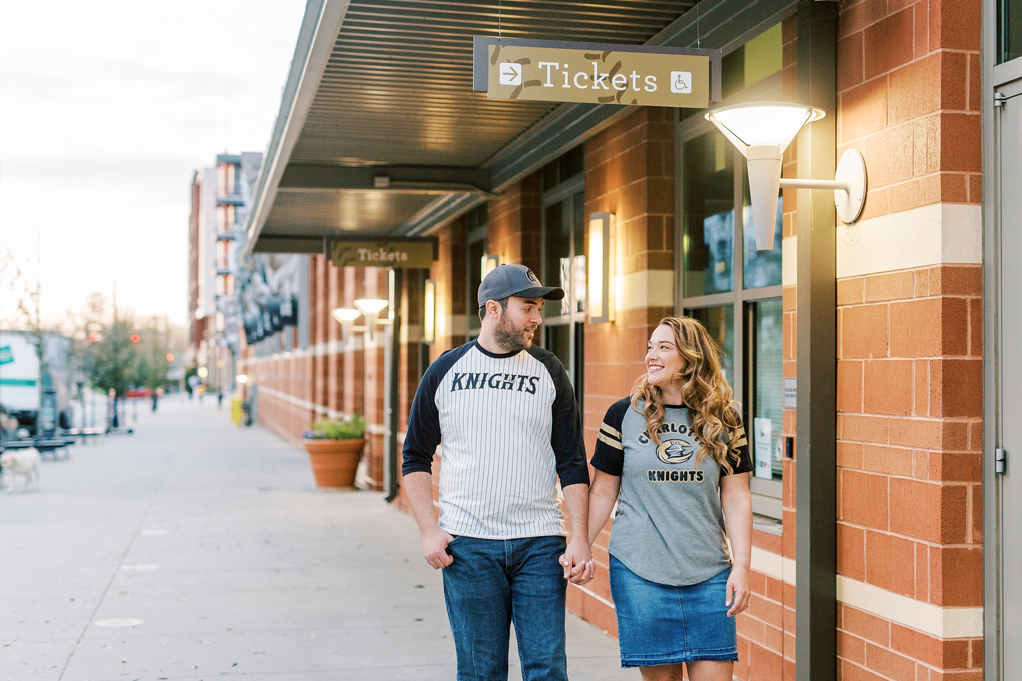 engagement portraits under the lights at Truist Field