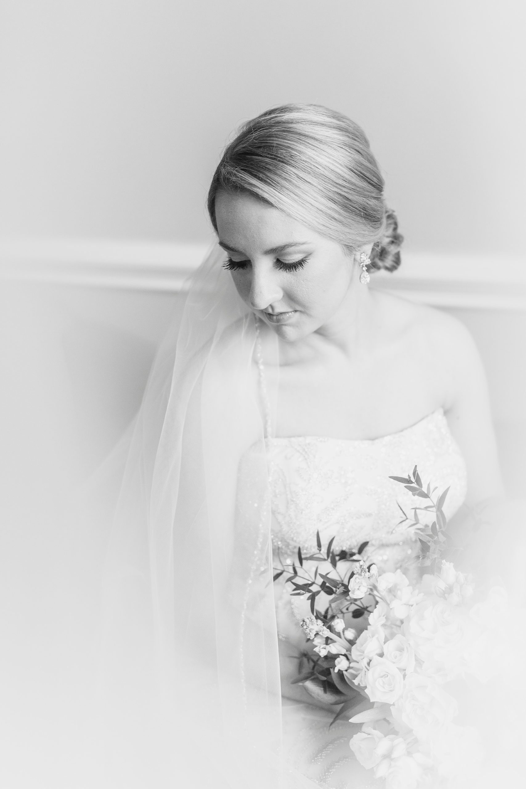 bride looks over shoulder during cathedral veil bridal portraits