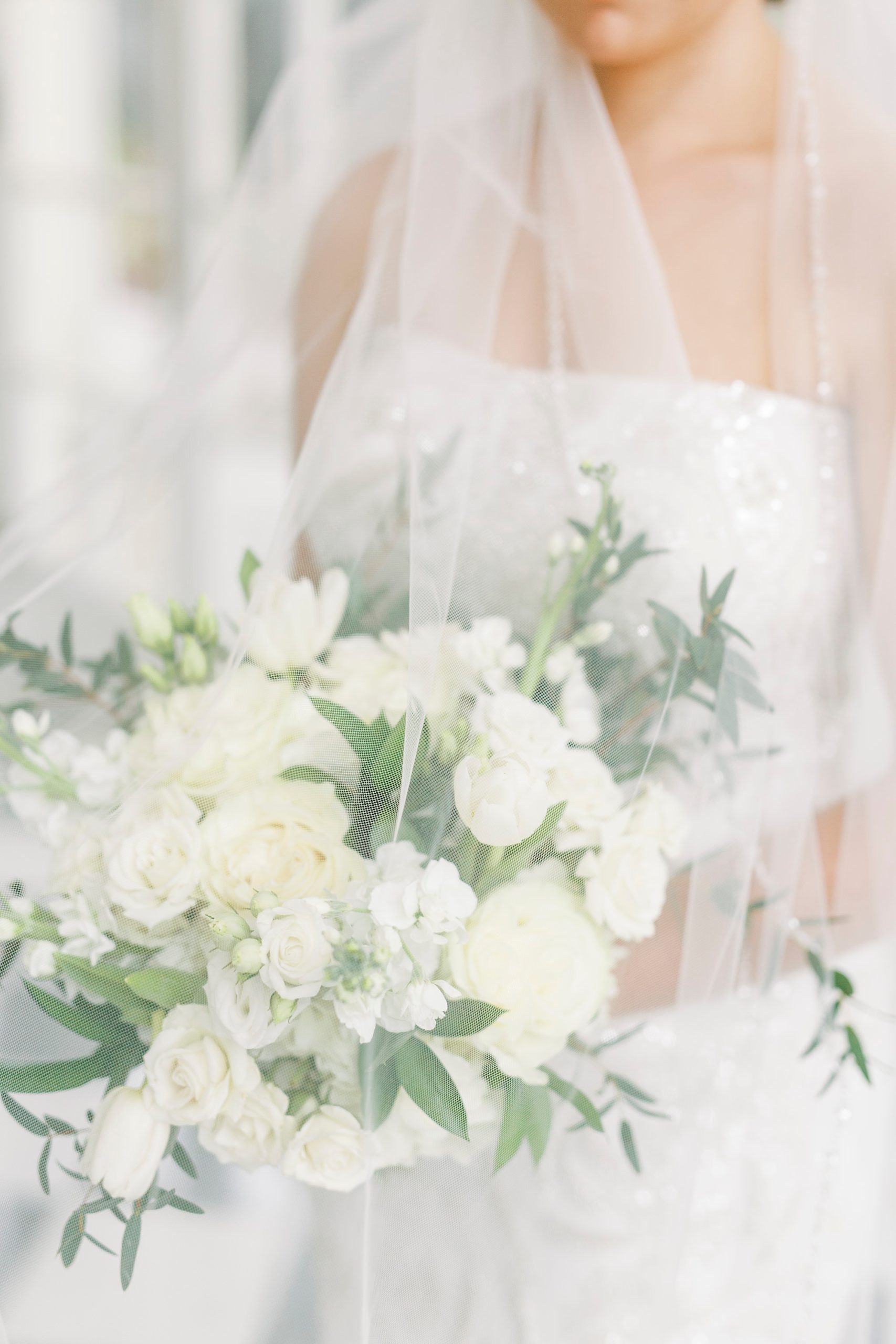 bride holds bouquet of all-white flowers in Separk Mansion