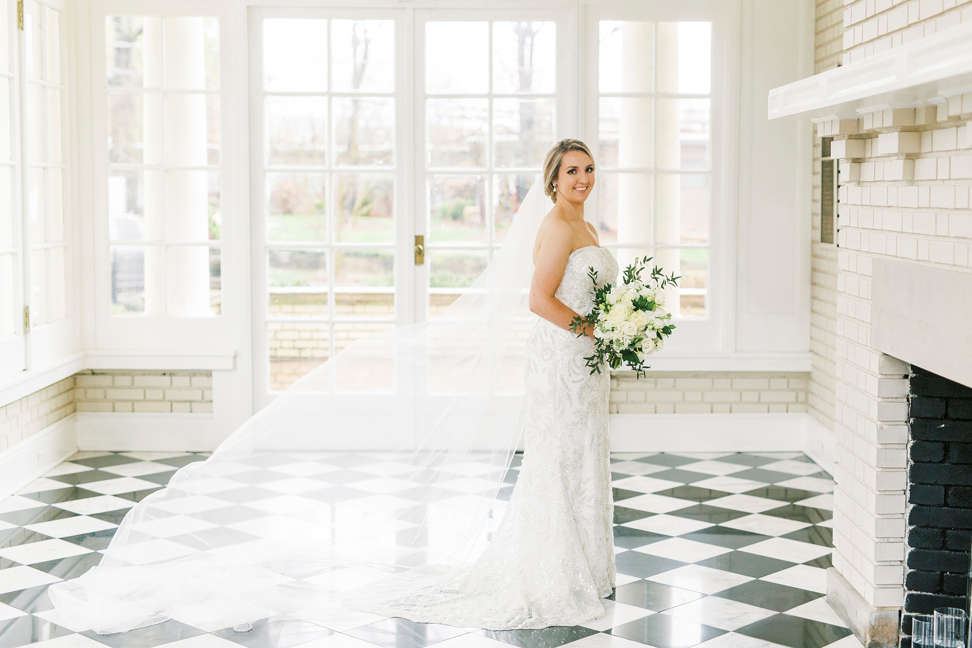 bride poses in Separk Mansion with cathedral veil floating behind her