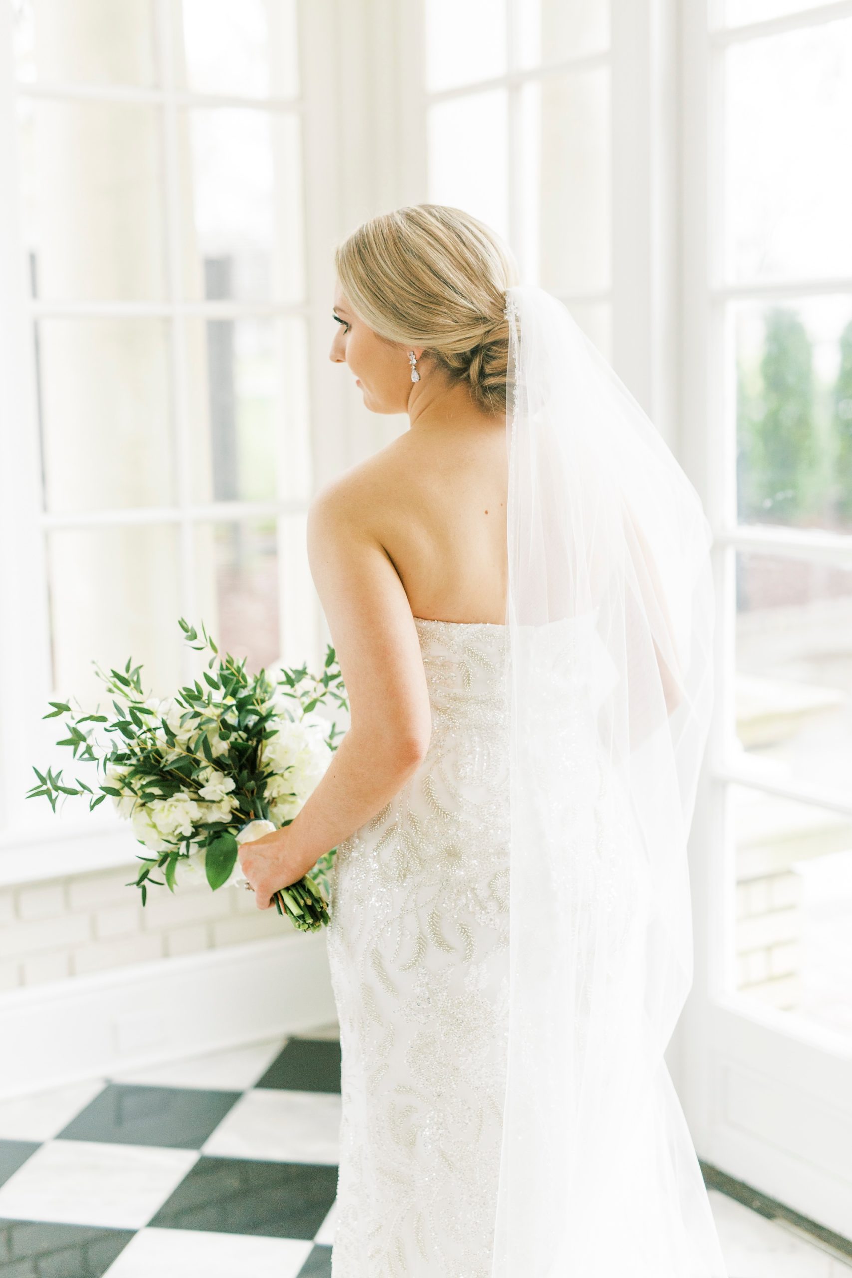 bride walks with veil trailing behind her