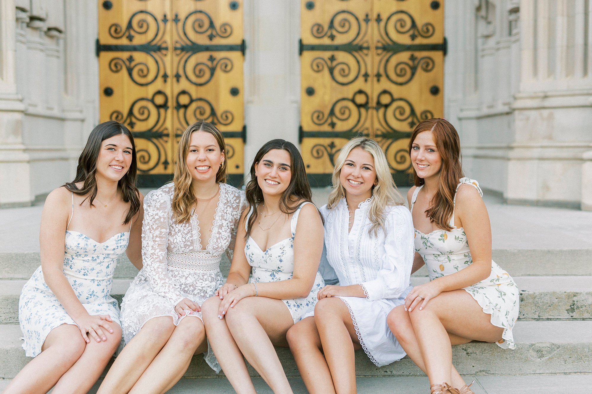 college seniors pose together by doors at Duke Chapel