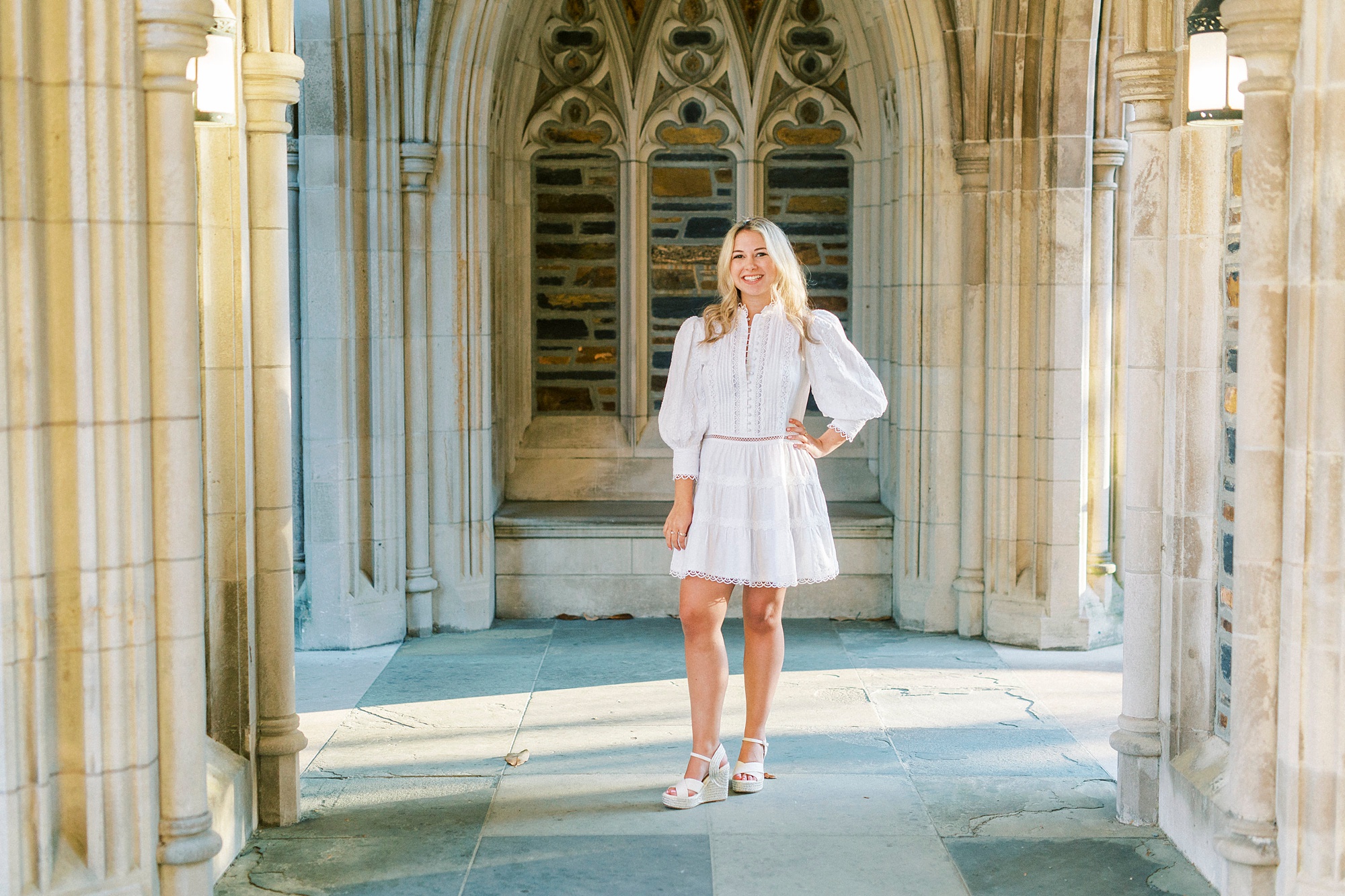 college senior poses by Duke Chapel
